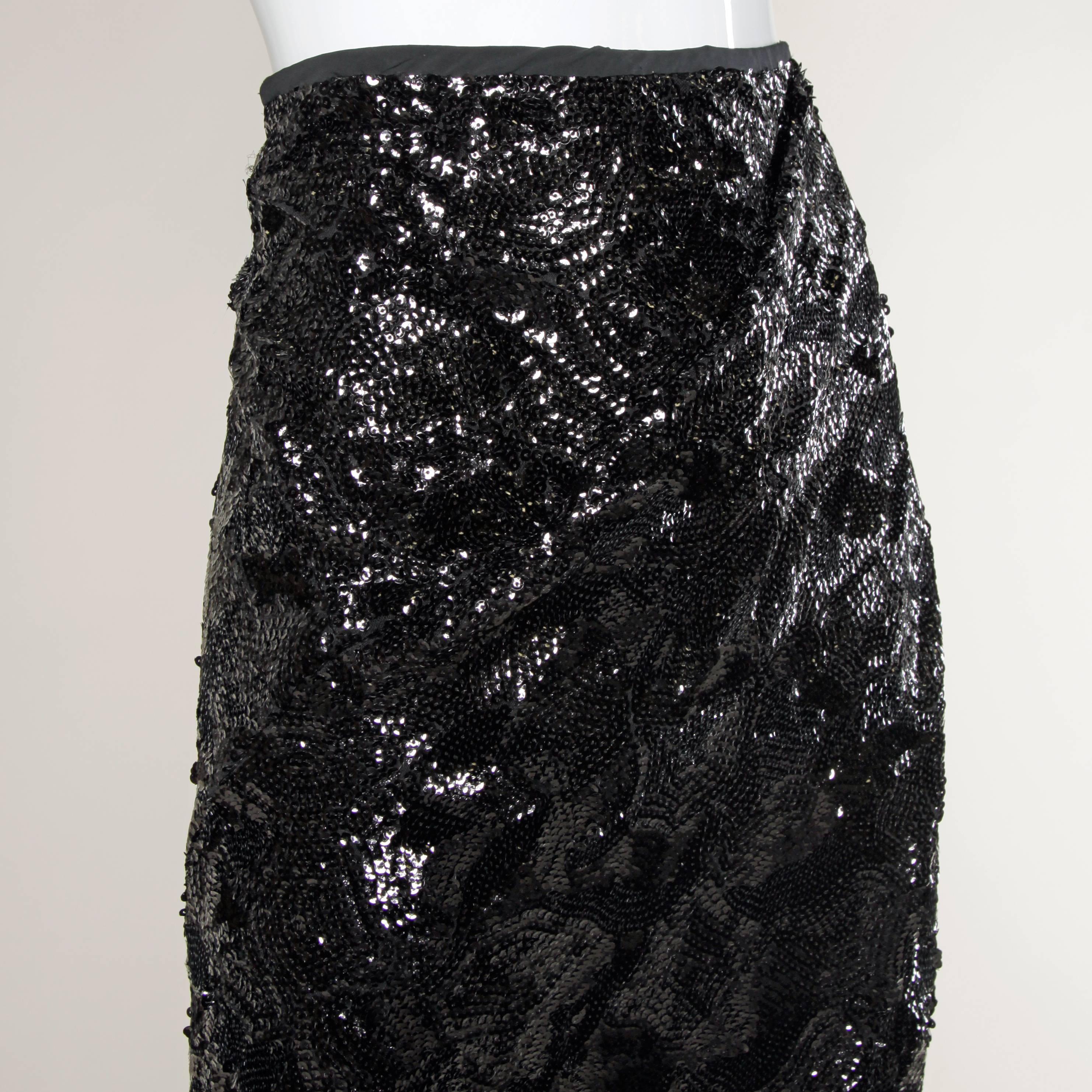 Gorgeous black sequin maxi skirt with an asymmetric slit by Donna Karan.

Details:

Fully Lined
No Closure/ Fabric Contains Stretch
Marked Size: Not Marked
Estimated Size: Small/ 6
Color: Iridescent Black/ Black
Fabric: Sequins
Label: