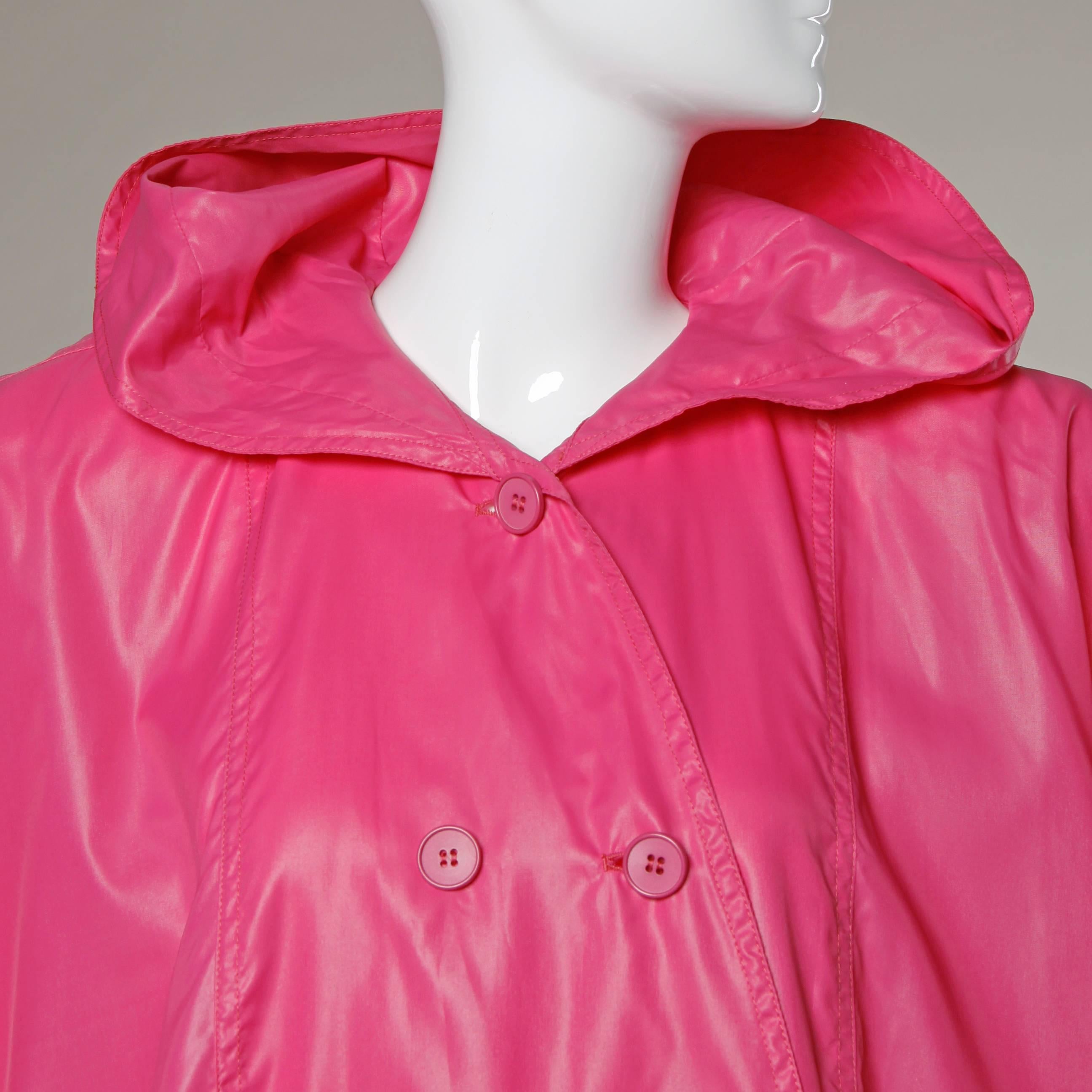 Bright pink rain coat by Salvatore Ferragamo with bat wing sleeves, swing shape and hood.

Details:

Unlined
Front Pockets
Shoulder Pads Can Easily Be Removed If Desired
Front Button Closure
Marked Size: One Size
Color: Bright Pink
Fabric: