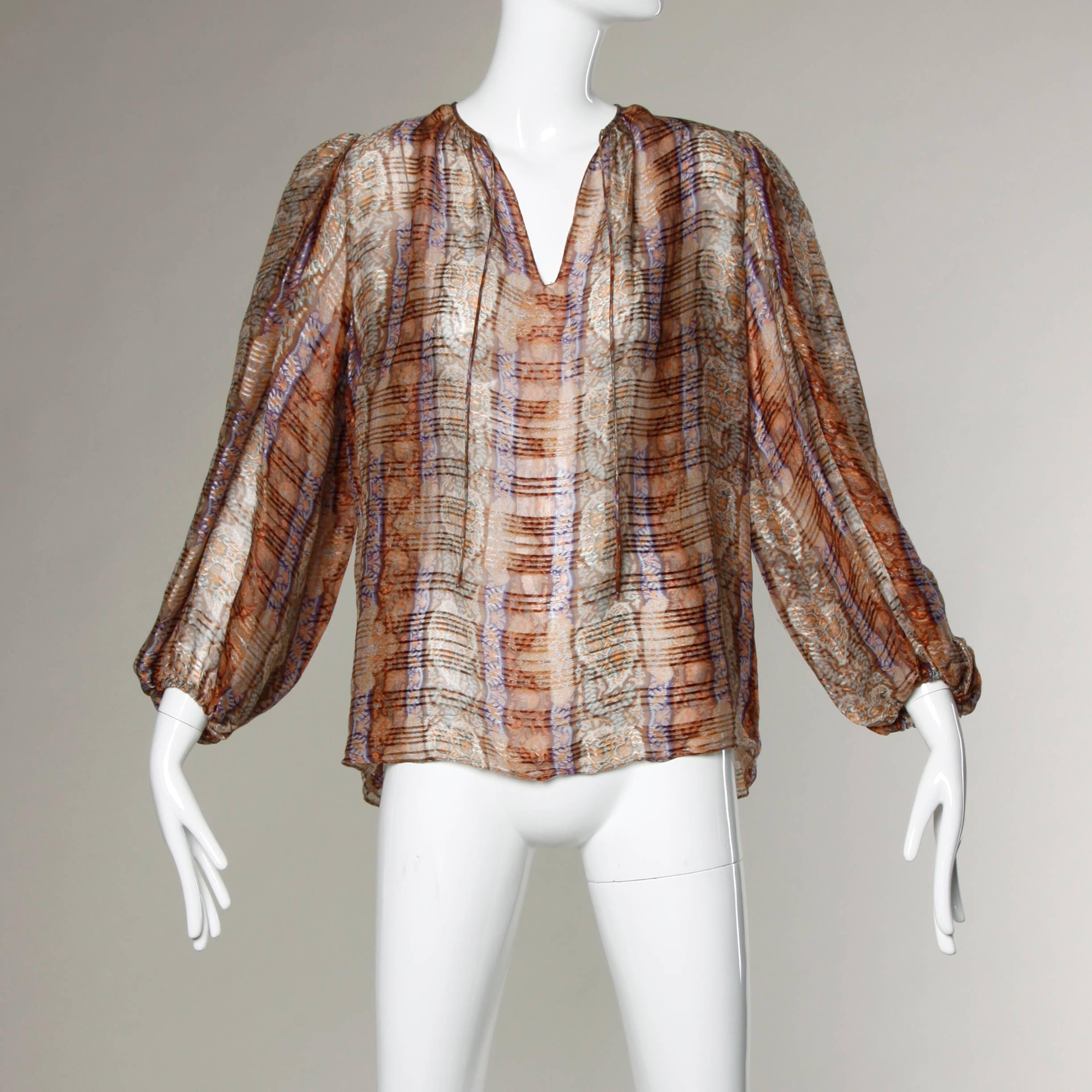 Stunning paper thin sheer printed silk blouse with full balloon sleeves. This has the look and feel of a Pauline Trigere blouse but there is only the Frances Heffernan brand label.

Details:

Unlined
No Closure
Marked Size: Not