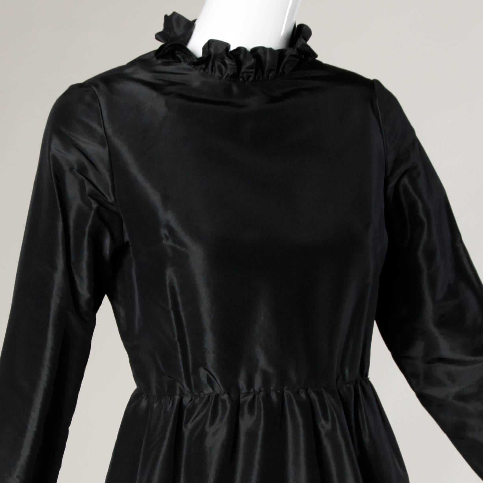 Gorgeous vintage 1970s black silk cocktail dress with ruffled trim by Oscar de la Renta.

Details:

Fully Lined
Side Pockets
Back Zip and Hook Closure
Marked Size: Not Marked
Estimated Size: S-M
Color: Black
Label: Oscar De La