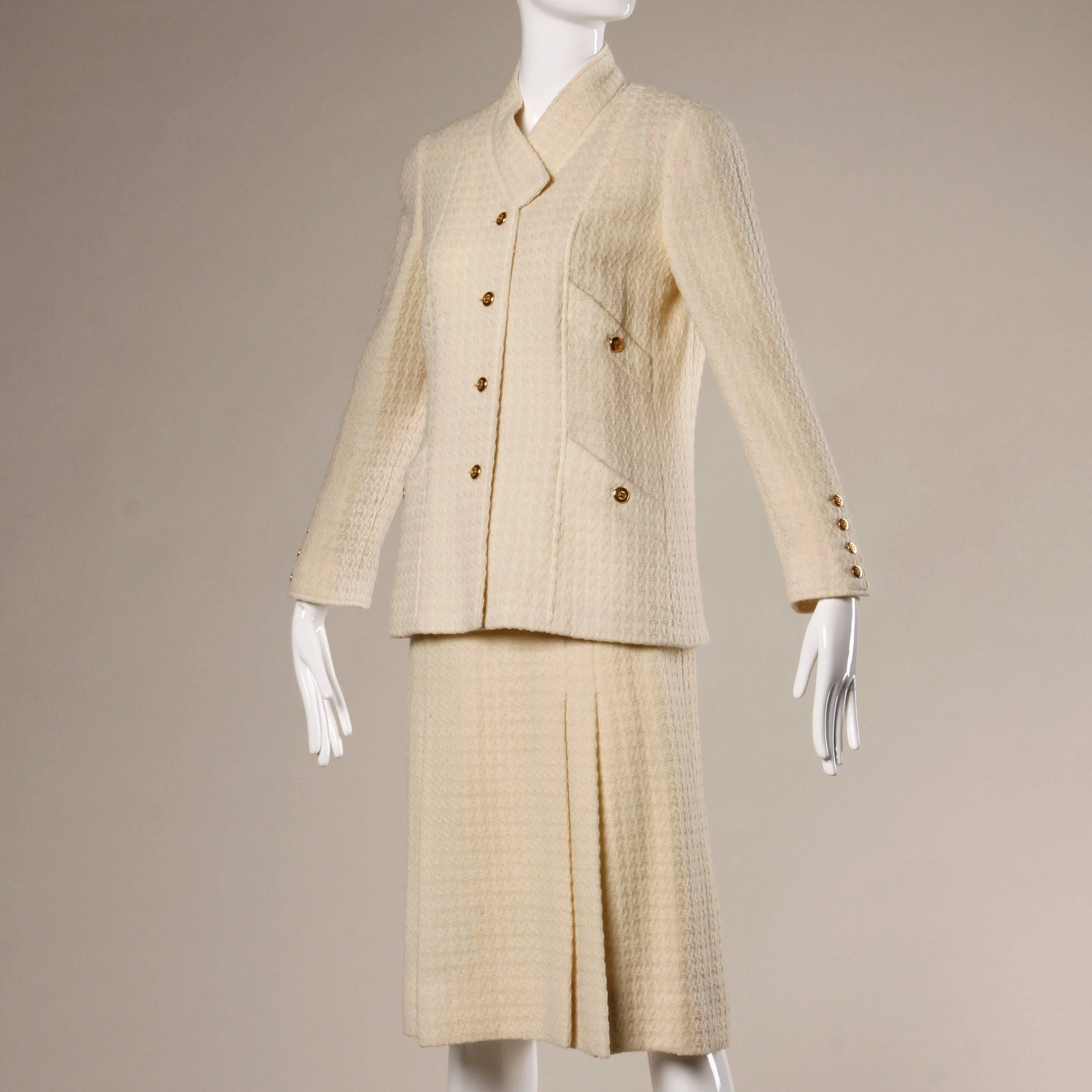 Absolutely stunning vintage woven wool Chanel suit featuring a tailored double breasted jacket and skirt set. Completely lined in creamy silk, this set has iconic 