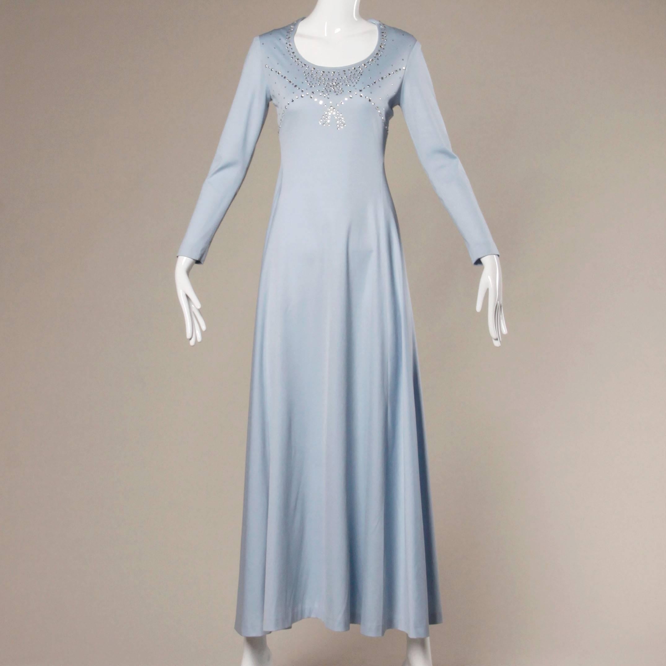 Gorgeous vintage 1970s jersey knit maxi dress with prong-set rhinestones and long sleeves. Scoop neck and long length.

Details:

Unlined
Back Zip and Hook Closure 
Marked Size: Not Marked
Estimated Size: Medium
Color: Pale Blue
Fabric:
