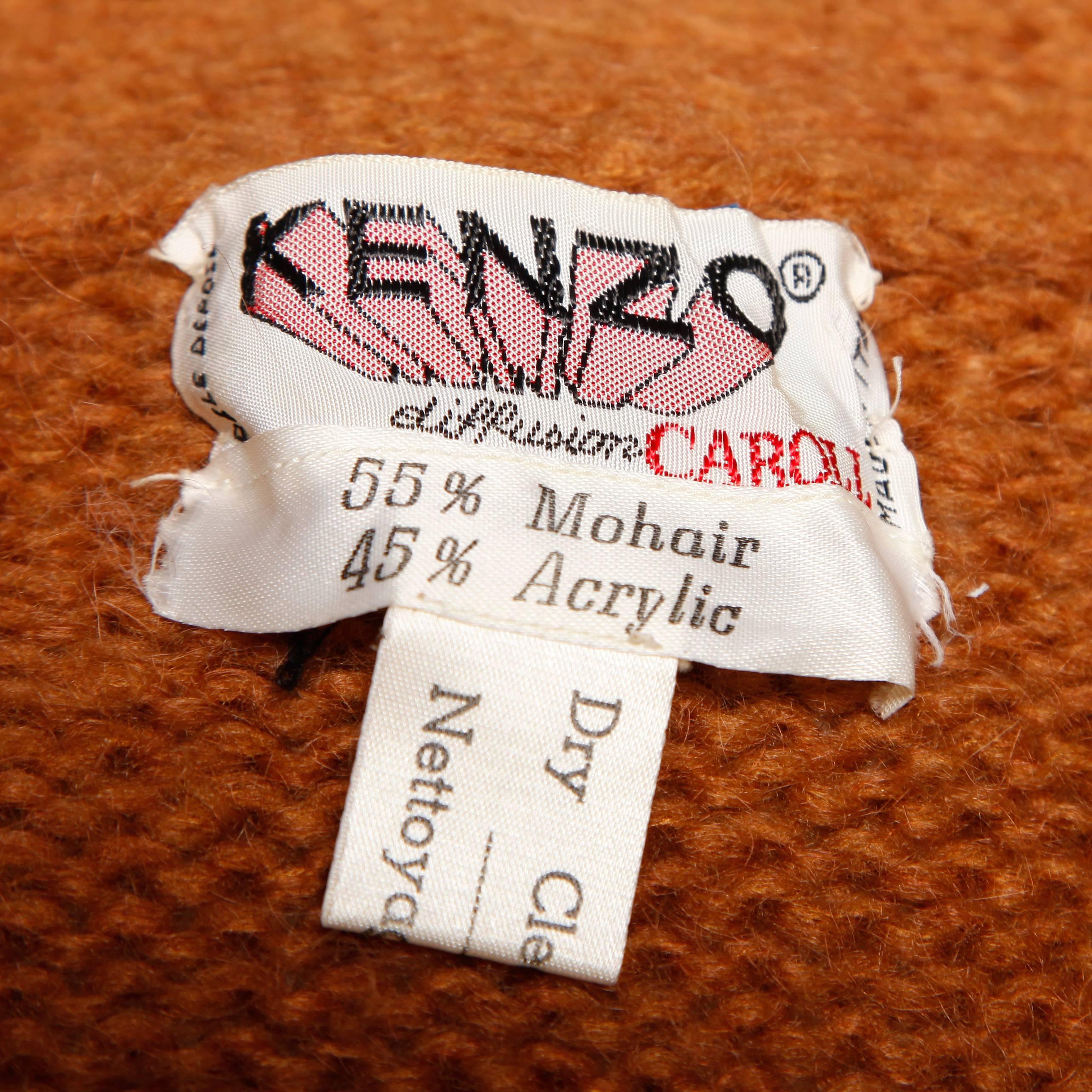 Amazing vintage chunky knit cocoon jacket by Kenzo. Fringe trim and matching waist sash tie.

Details: 

Unlined
Front Pockets
Sash Tie Closure
Marked Size: Not Marked
Estimated Size: Free
Color: Camel
Fabric: 55% Mohair/ 45%
