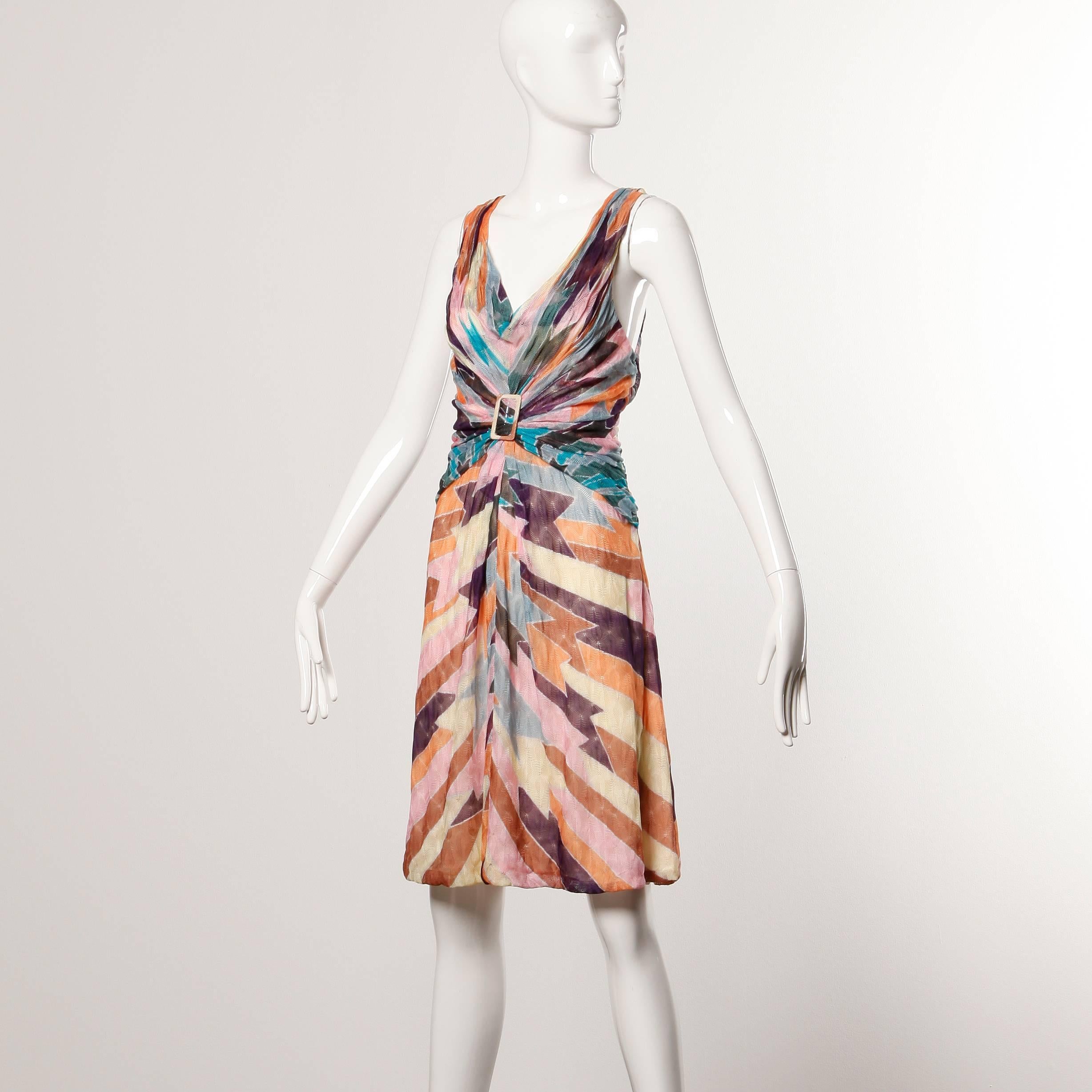 Colorful knit Missoni dress with ruched buckle detail in front and in back.

Details: 

Partially Lined in Silk
Side Zip Closure
Estimated Size: Medium
Color: Purple/ Blue/ Tan/ Yellow/ Grey
Fabric: 100% Rayon Knit
Label: