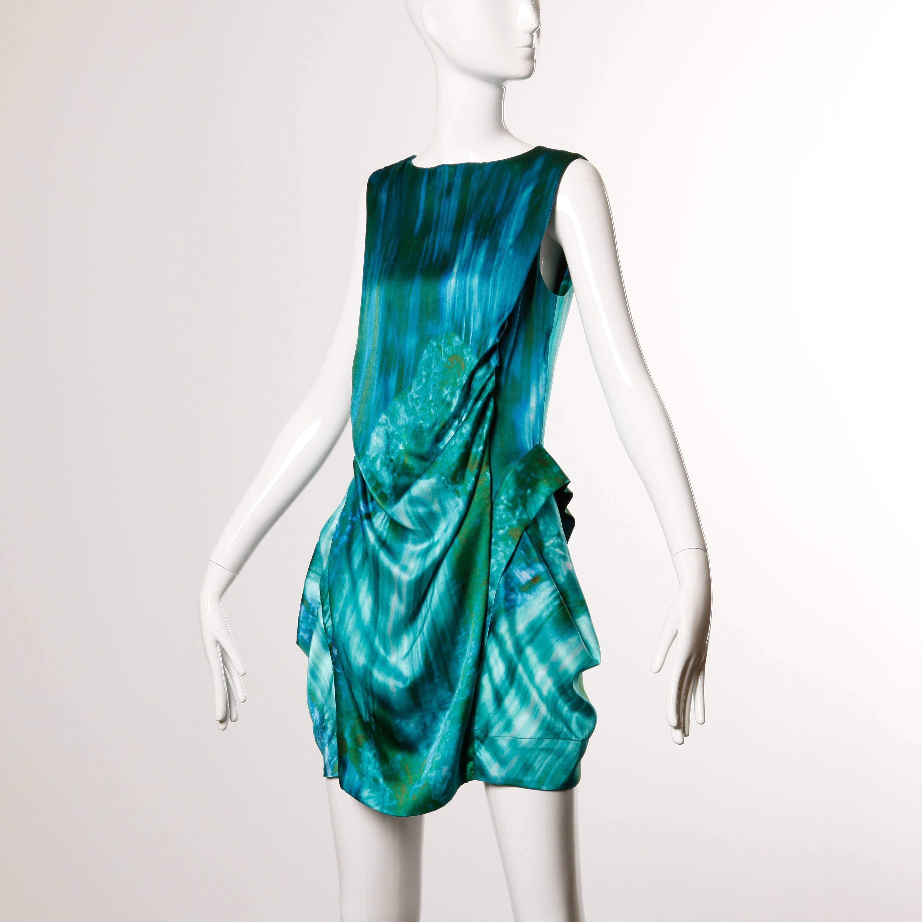 Unique water color photo print dress in shades of blue and green silk by Peter Pilotto.

Details: 

Partially Lined
Back Zip Closure
Marked Size: UK 10
Estimated Size: S-M
Color: Blue/ Green
Fabric: 100% Silk
Label: Peter
