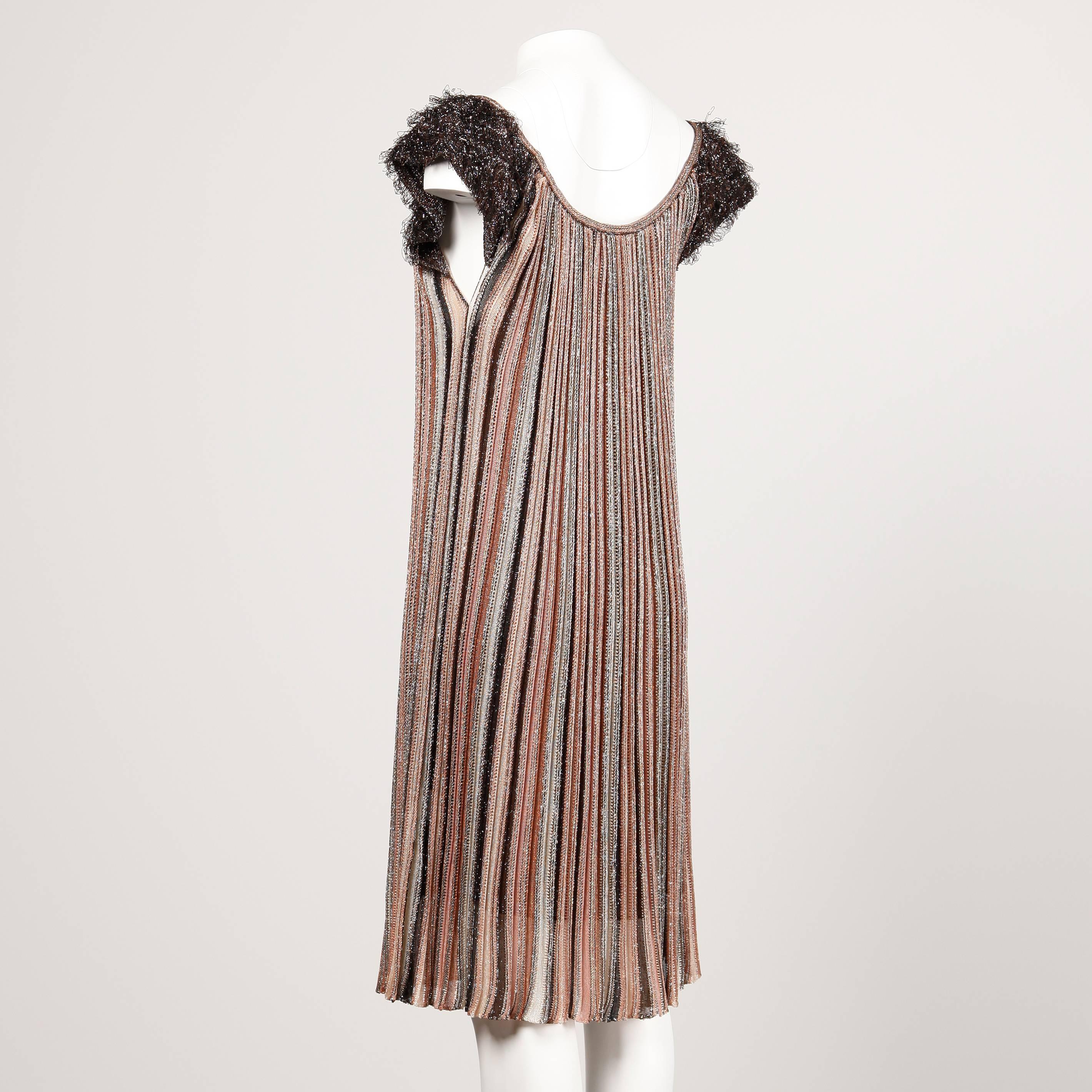 Sparkly metallic knit striped trapeze dress with shaggy looped fringe cap sleeves by Missoni.

Details: 

Fully Lined
No Marked Size
Estimated Size: S-M
Color: Black/ Brown/ Gold/ Peach/ Metallic Knit
Fabric: 100% Nylon
Label: M