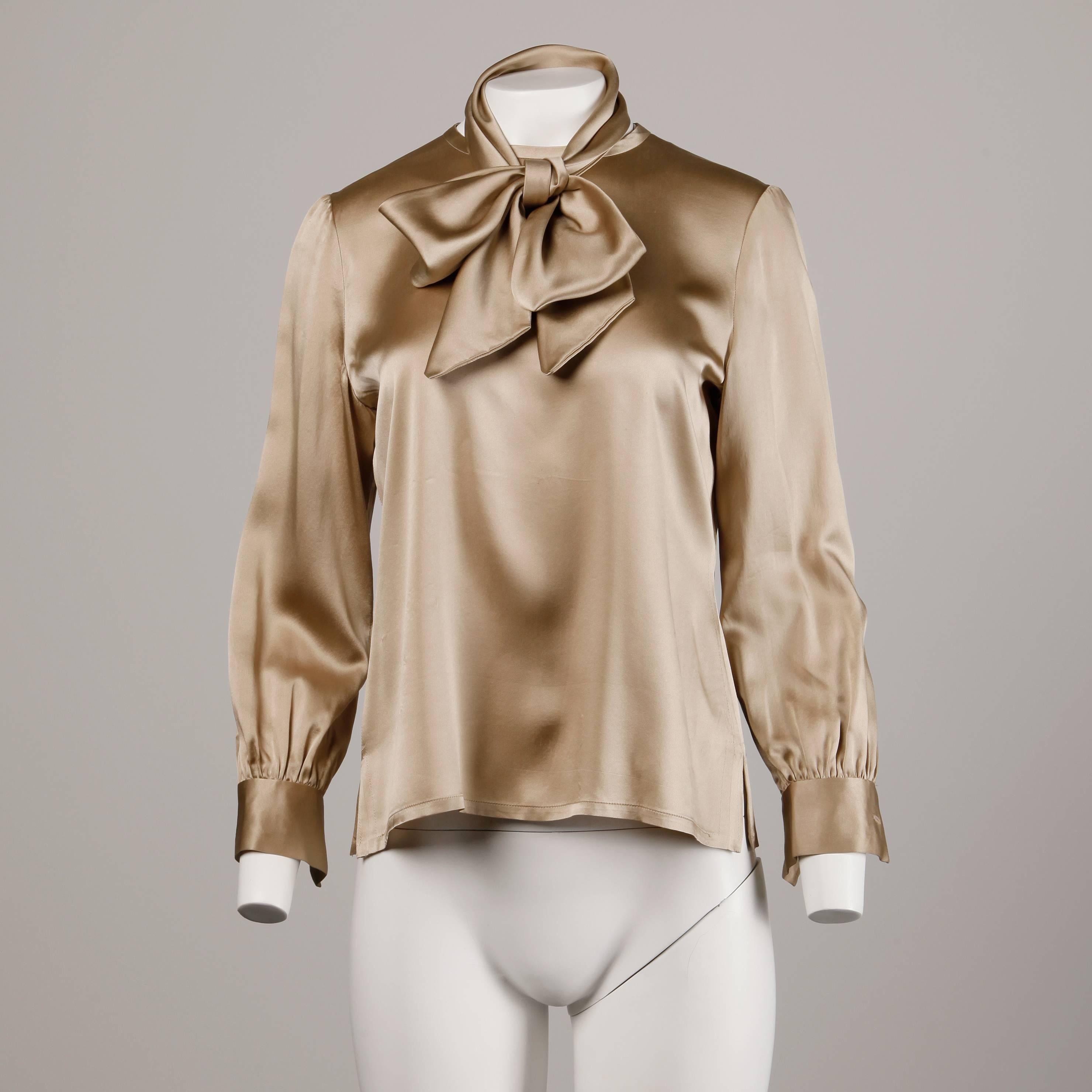 Gorgeous vintage champagne silk blouse with an optional ascot bow sash. The blouse buttons up the back and is made from high quality medium weight silk. The condition is excellent with no damage. However the blouse appears to have been let out on