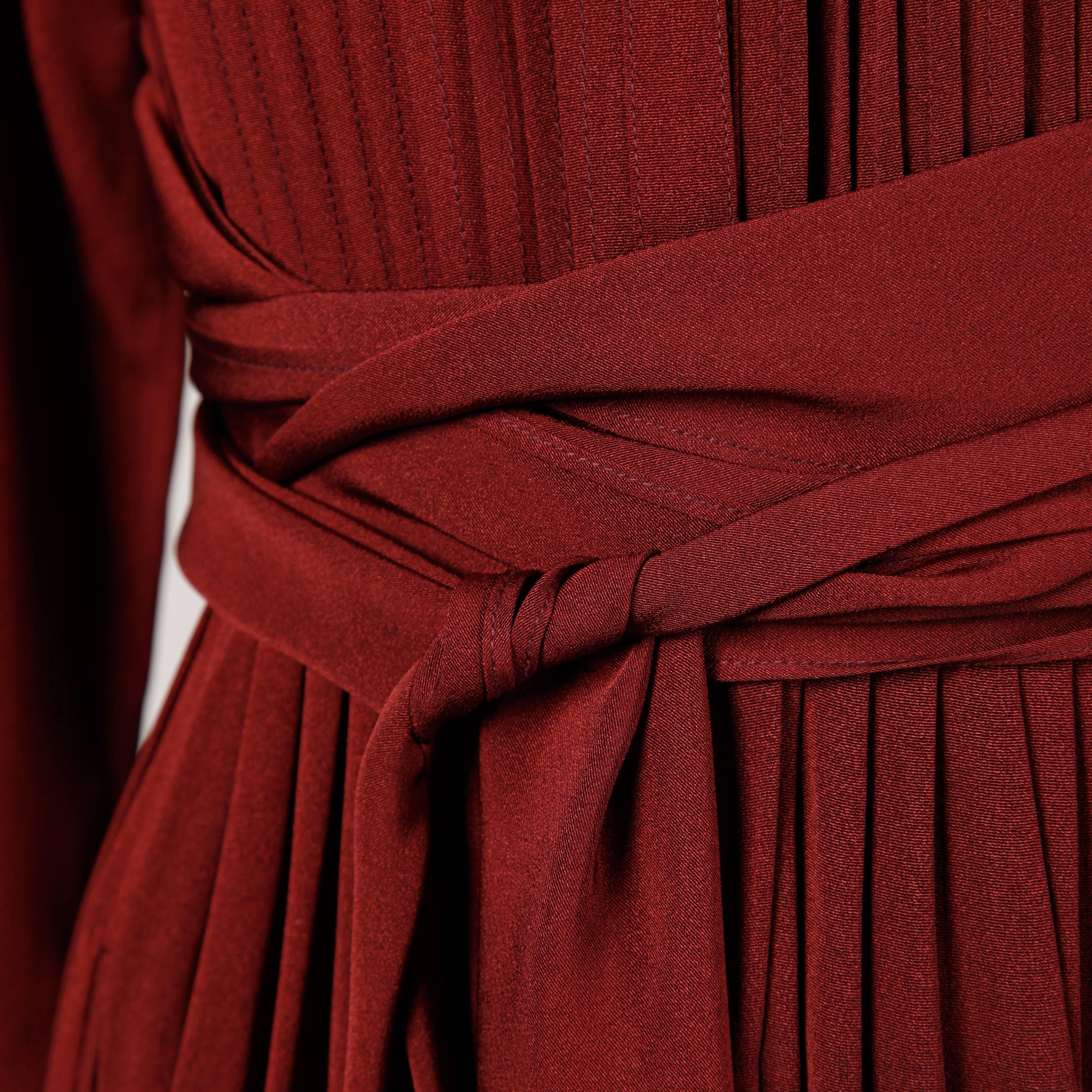 Deep burgundy dress by Albert Nipon for I. Magnin. Pin tuck pleats, full balloon sleeves and wrap around sash.

Details: 

Unlined
Front Slit Pockets
Button Front Closure
Marked Size: Unmarked
Estimated Size: Small
Color: Burgundy
Label:
