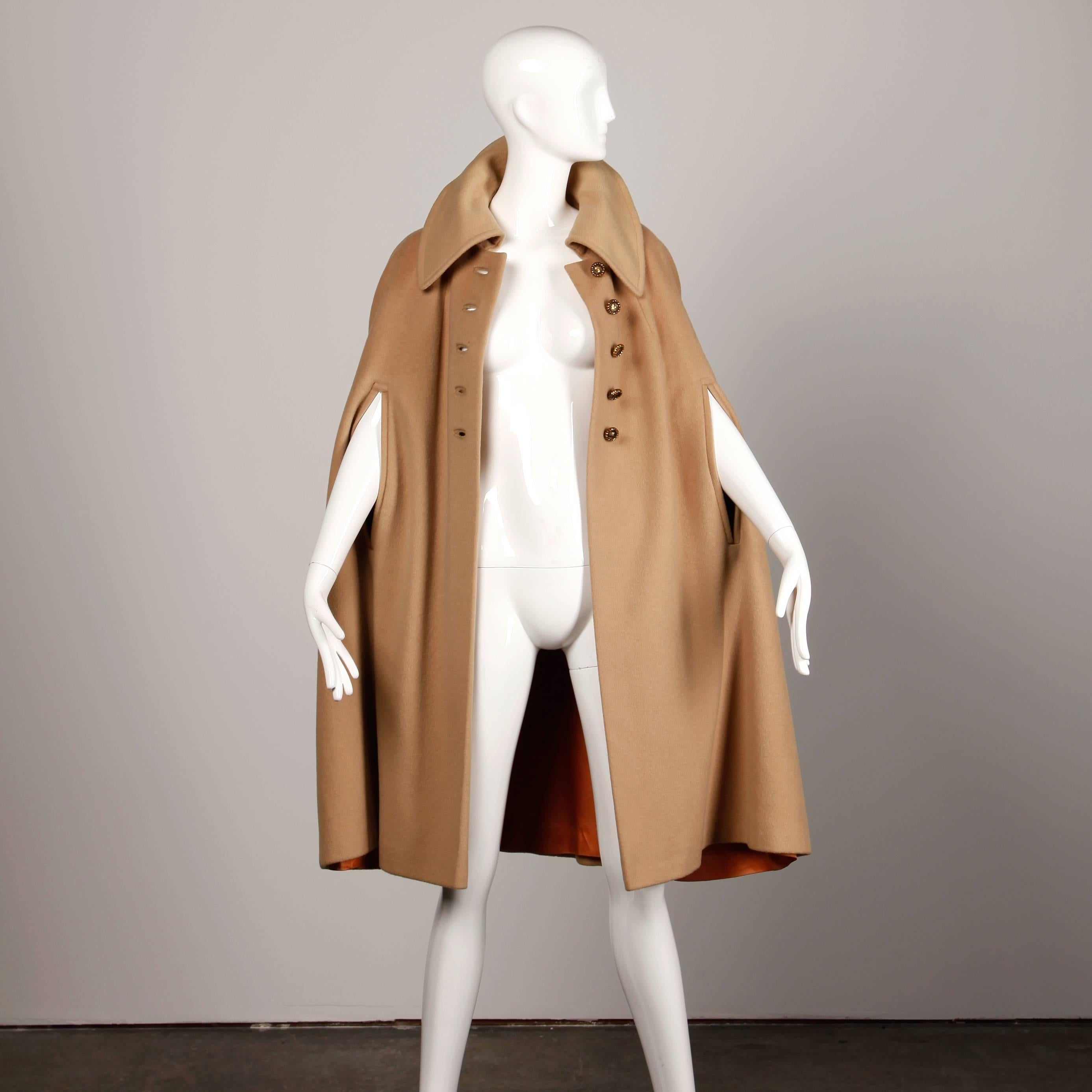 Chic vintage 1970s camel wool cape coat with oversized collar and arm slits.

Details: 

Fully Lined
Button Front Closure
Marked Size: Unmarked
Estimated Size: Free (S-L
Color: Camel
Fabric: Wool
Label: Youthcraft

Measurement: 
Total