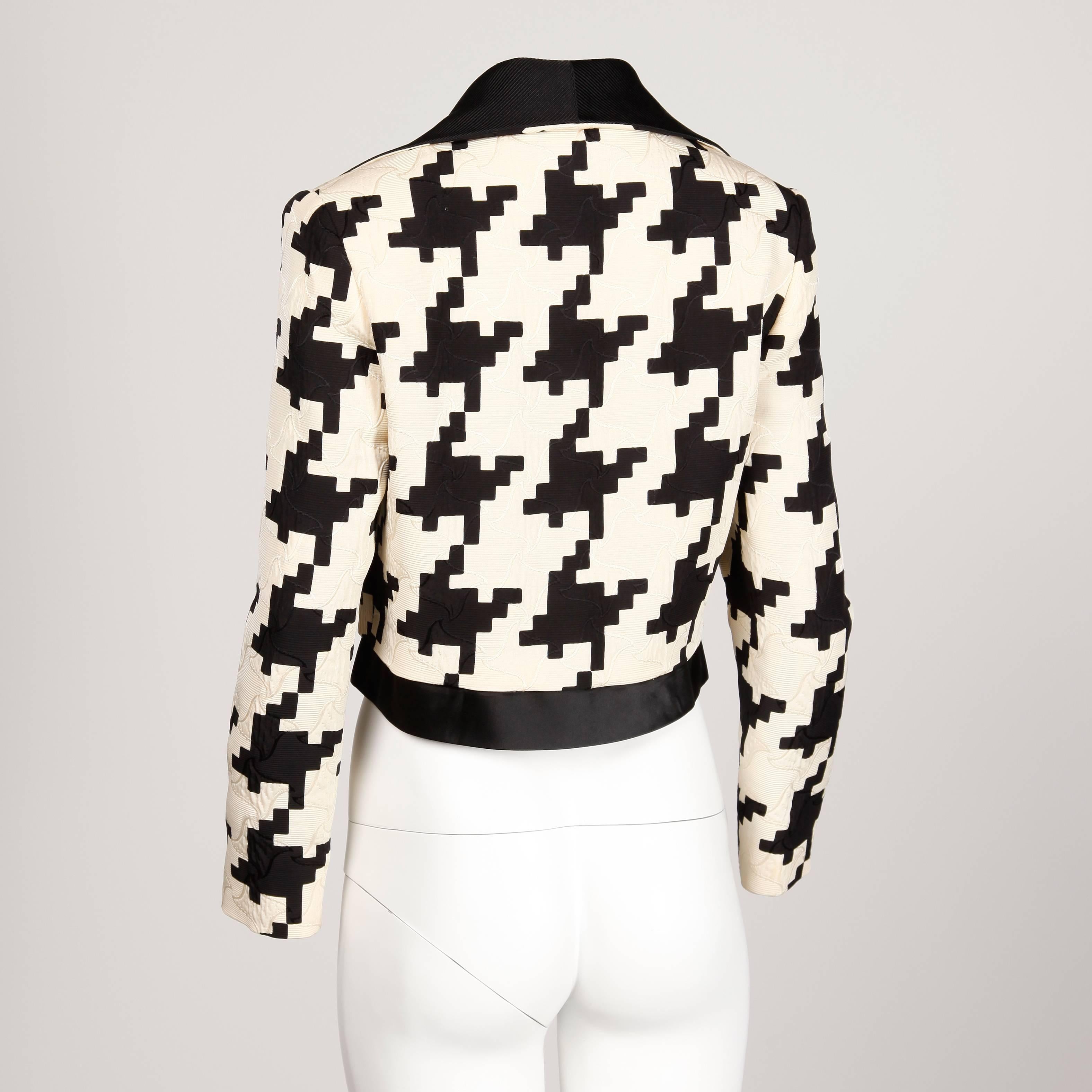 Amazing vintage oversized houndstooth print jacket by Gianni Versace for Genny. Beautiful silk/ wool fabric and matching silk houndstooth lining. The jacket has a black collar and does not close in front. Very chic!

Details: 

Fully