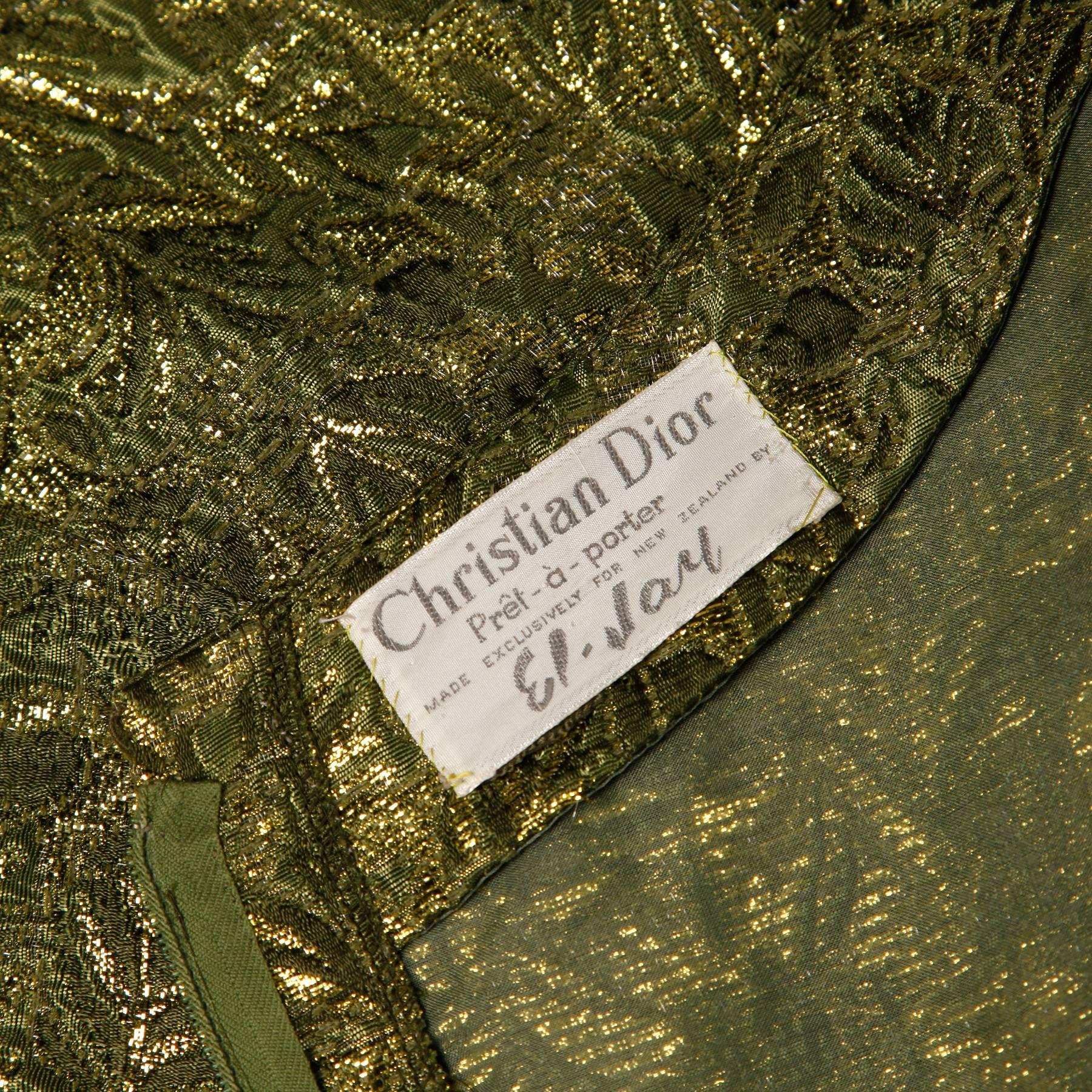 Ultra rare 1960s Christian Dior cocktail dress in metallic green and gold brocade. Empire waistline and button detail. The dress has a scoop neck and short sleeves. The construction of this dress is just gorgeous! It is fully lined in silk and is