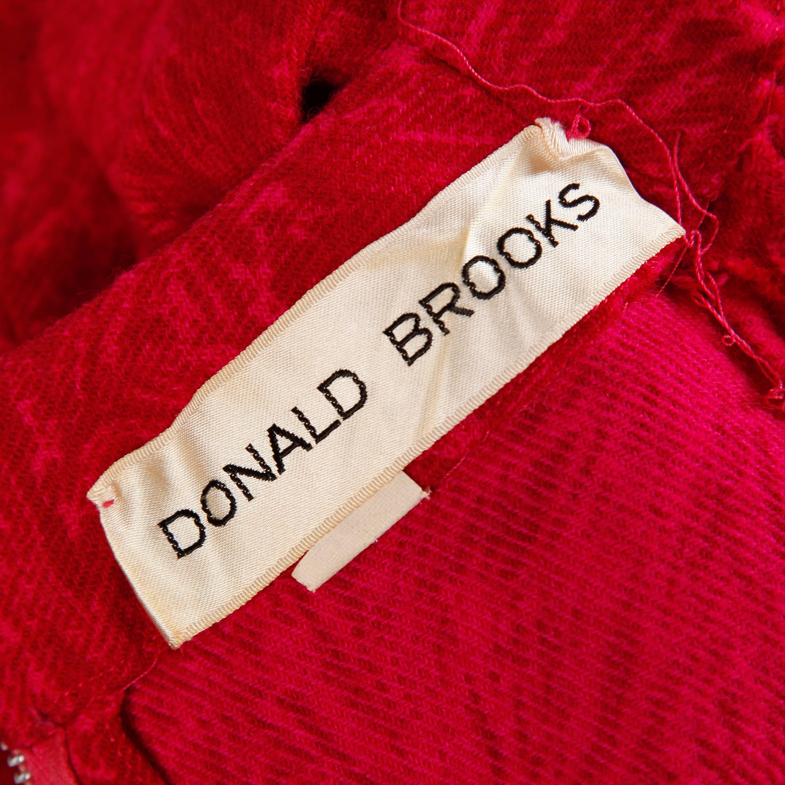 Rare early Donald Brooks! This is from one of Donald Brooks first collections in the early 1960s. The dress features woven wool in a pink and fuchsia swirl pattern, a long waist sash, and 3/4 length sleeves. Very flattering cut.

Details: