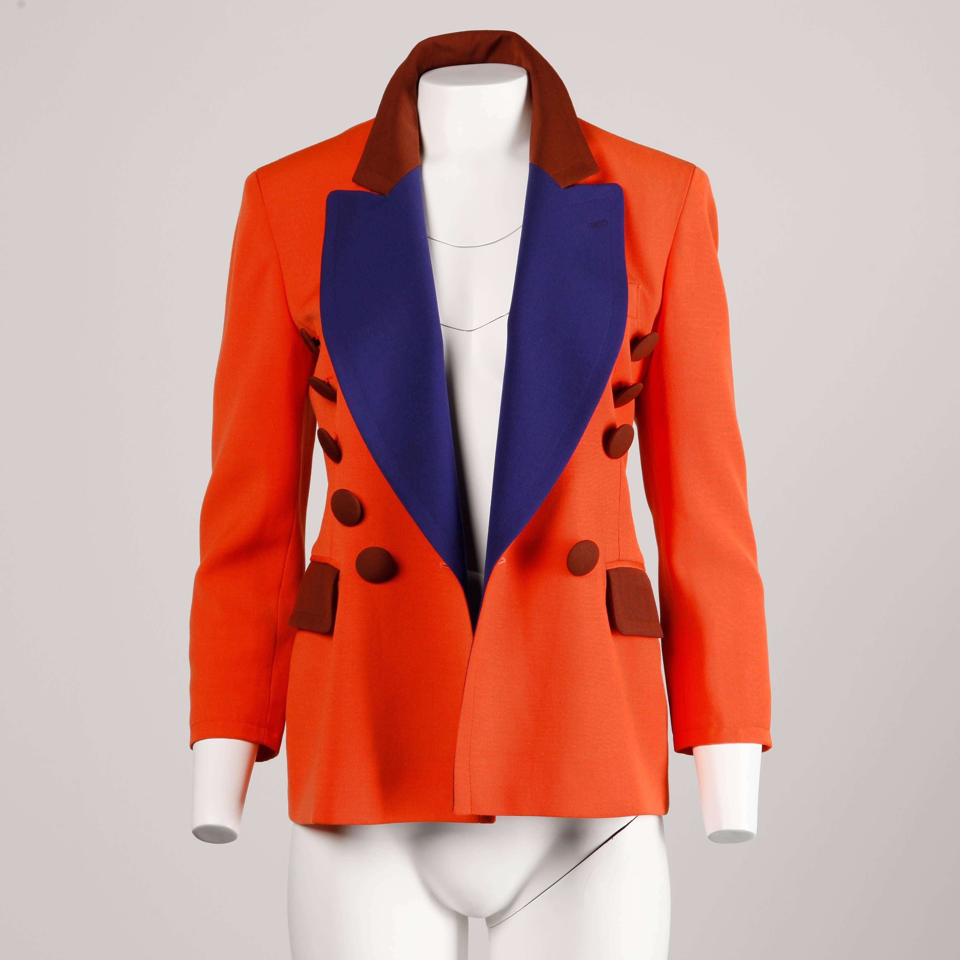 Vintage bright orange wool blazer jacket by Moschino Couture! with brown and blue buttons and lapels. Rare Franco Moschino pre-death design dates to the late 80s/ early 90s.

Details: 

Fully Lined
Front Placket Pockets
Marked Size: I 38/ D