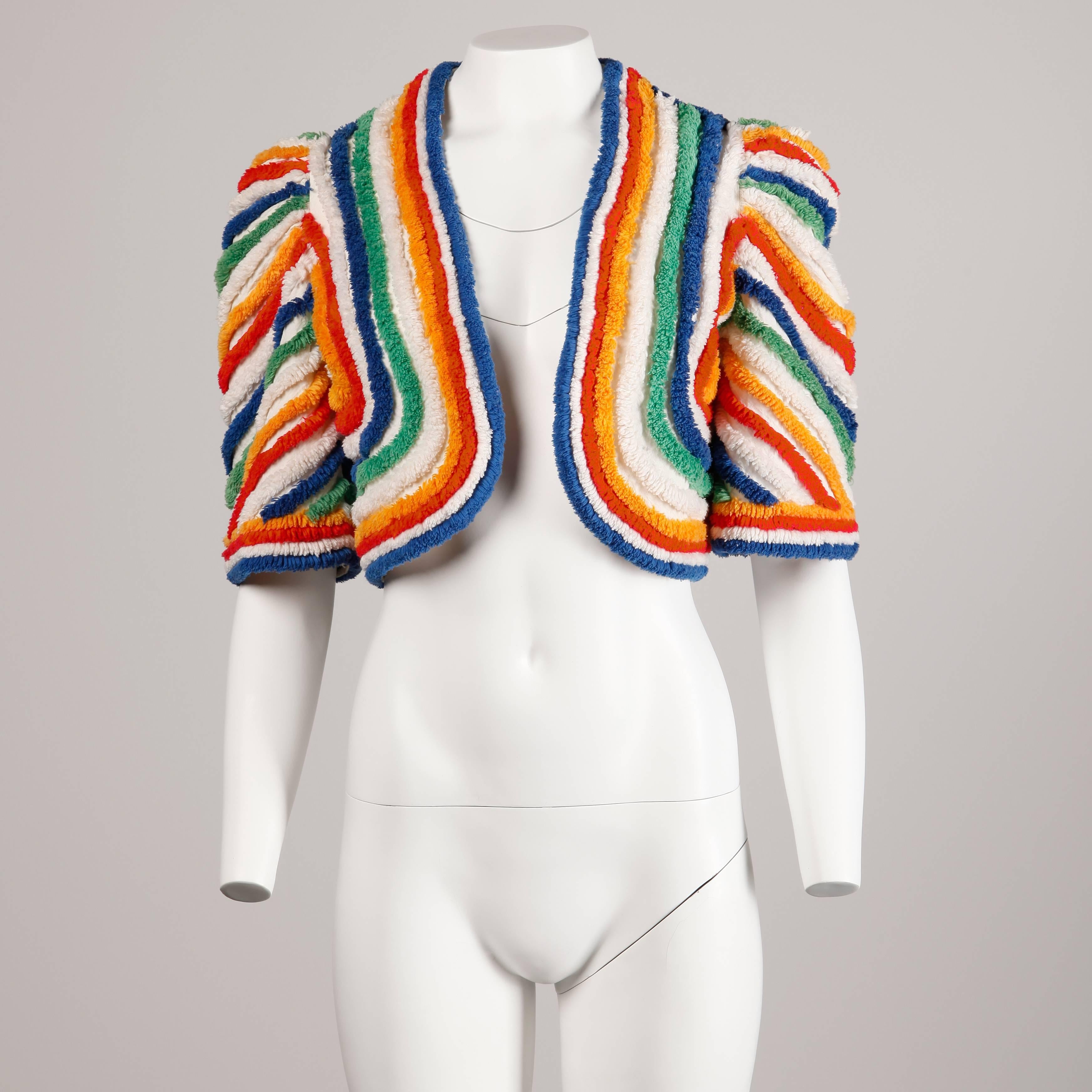 Incredible vintage 1940s bolero jacket in shaggy terry cloth rainbow stripes! Elbow length puff sleeves and cropped fit. So darling and completely unique!

Details: 

Unlined
Marked Size: Unmarked
Estimated Size: Small
Color: White/ Blue/