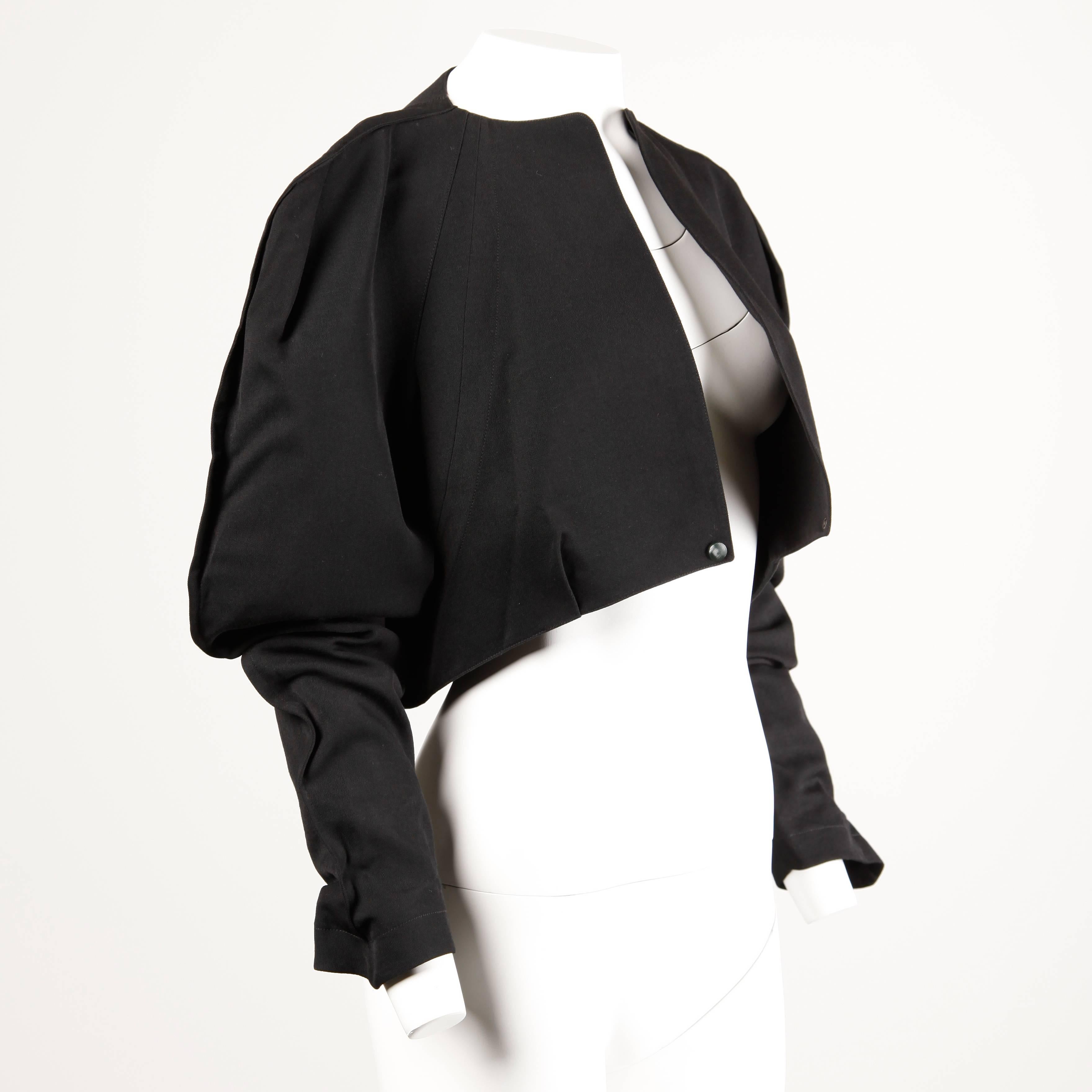 Amazing vintage avant garde jacket by Thierry Mugler from the 1980s! Chic black wool fabric with a avant garde silhouette and oversized sleeves. Single snap closure at the front of the jacket.

Details: 

Fully Lined
Bottom Front Snap