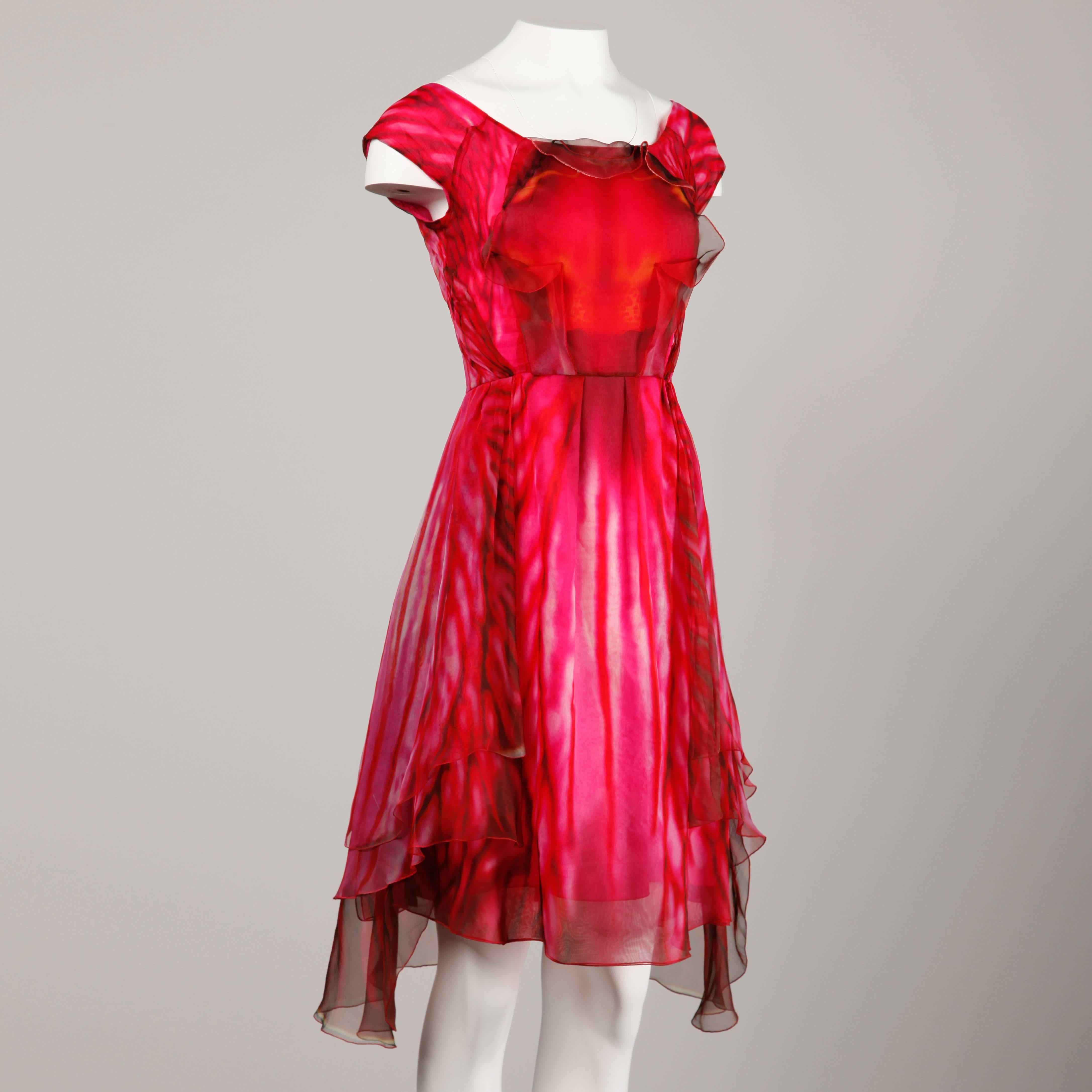 Incredible paper thin silk dress by Celine! Gorgeous orchid flower design in shades of fuchsia and pink silk. We have seen botanicals in fashion before but never quite like this!

Details: 

Fully Lined in Silk
Back Zip with Hook