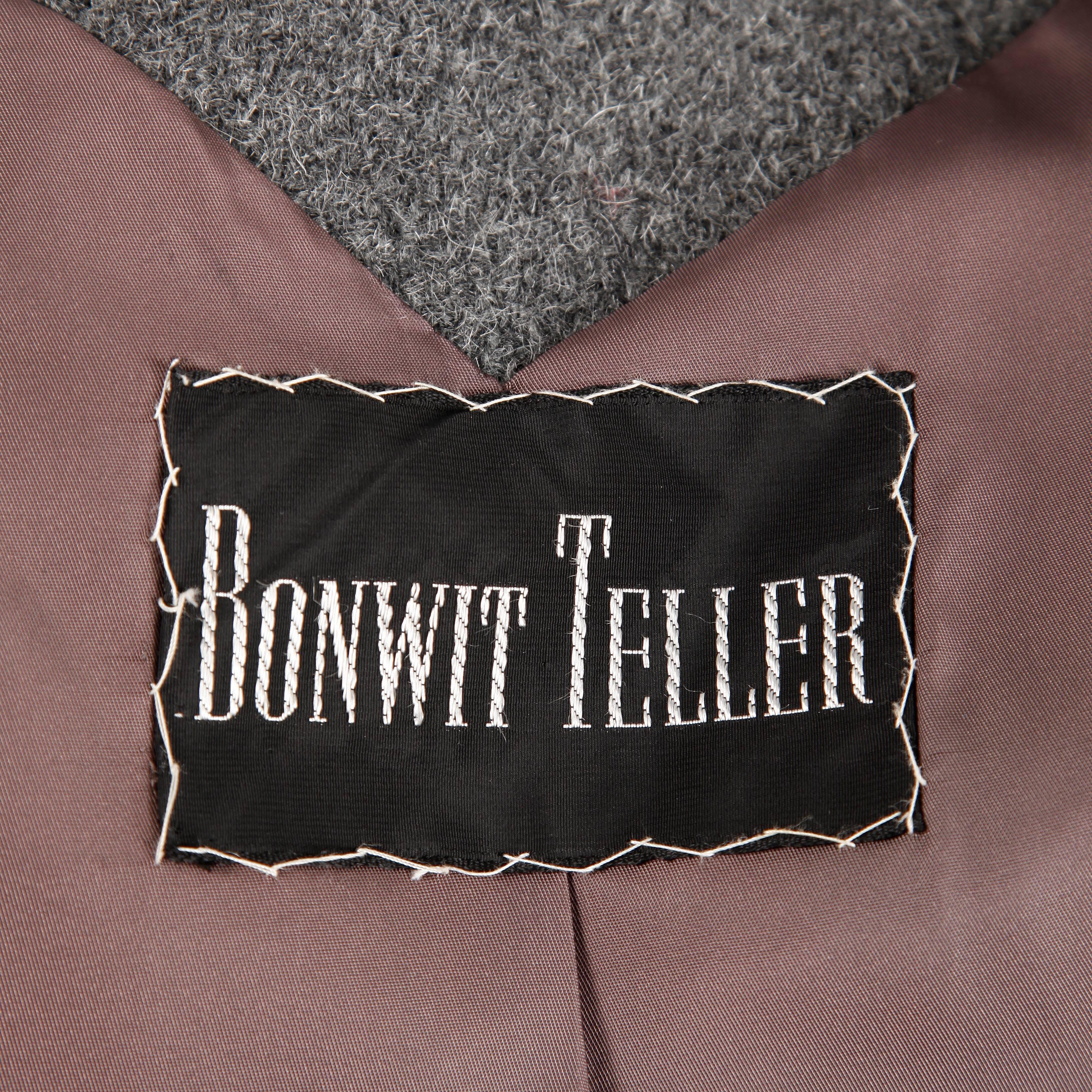 Winter weight heavy wool military-inspired coat by Bonwit Teller. This is well made to keep you warm on the chilliest of days! Gorgeous construction with heavy satin lining and metal buttons.

Details: 

Fully Lined
Side Seam Pockets
Button