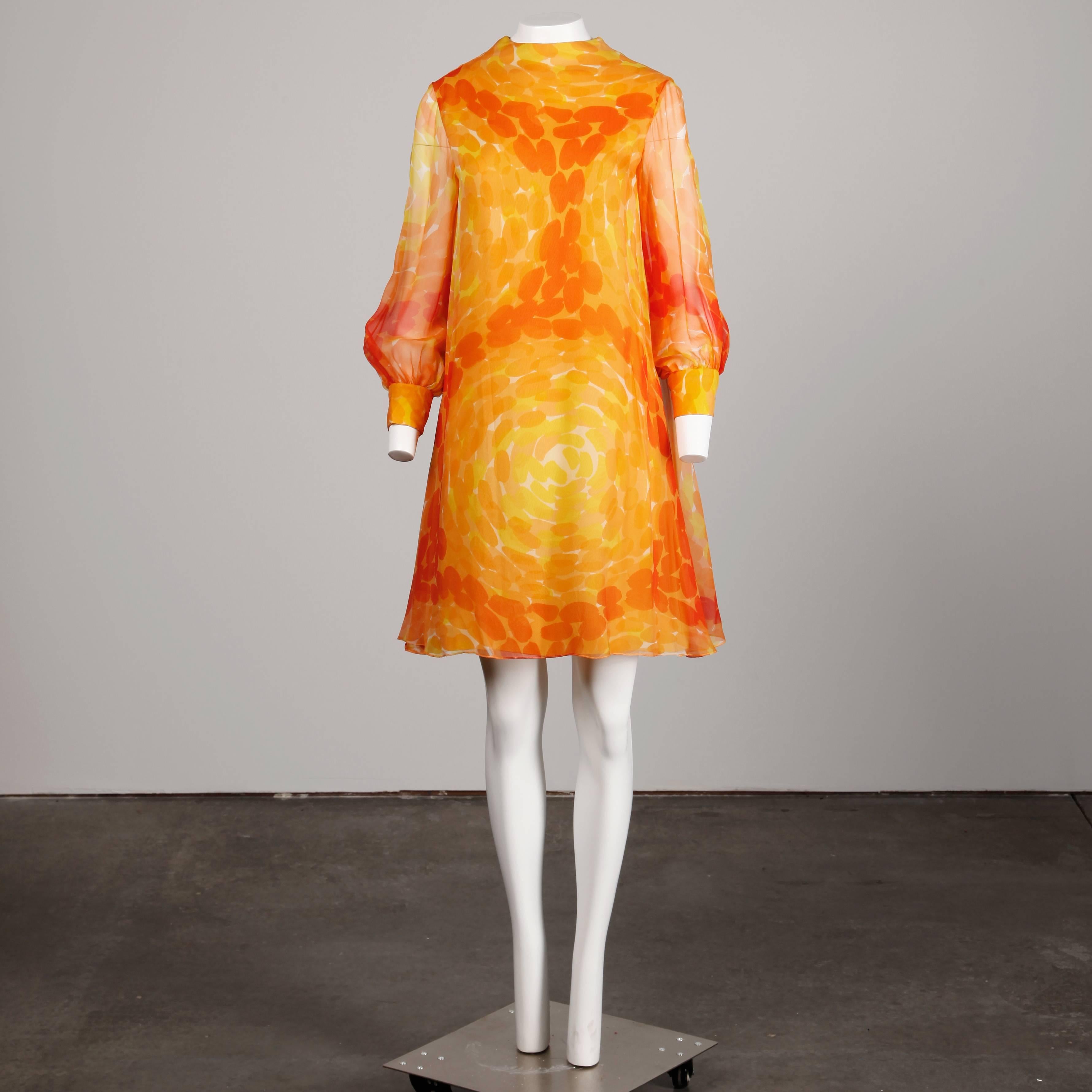 Amazing 1960s vintage screen printed mod dress by Pab. Long sheer sleeves and vibrant print in orange and yellow.

Details: 

Partially Lined
Back Zip with Hook Closure
Marked Size: Unmarked
Estimated Size: Small
Color: Yellow/ Red/