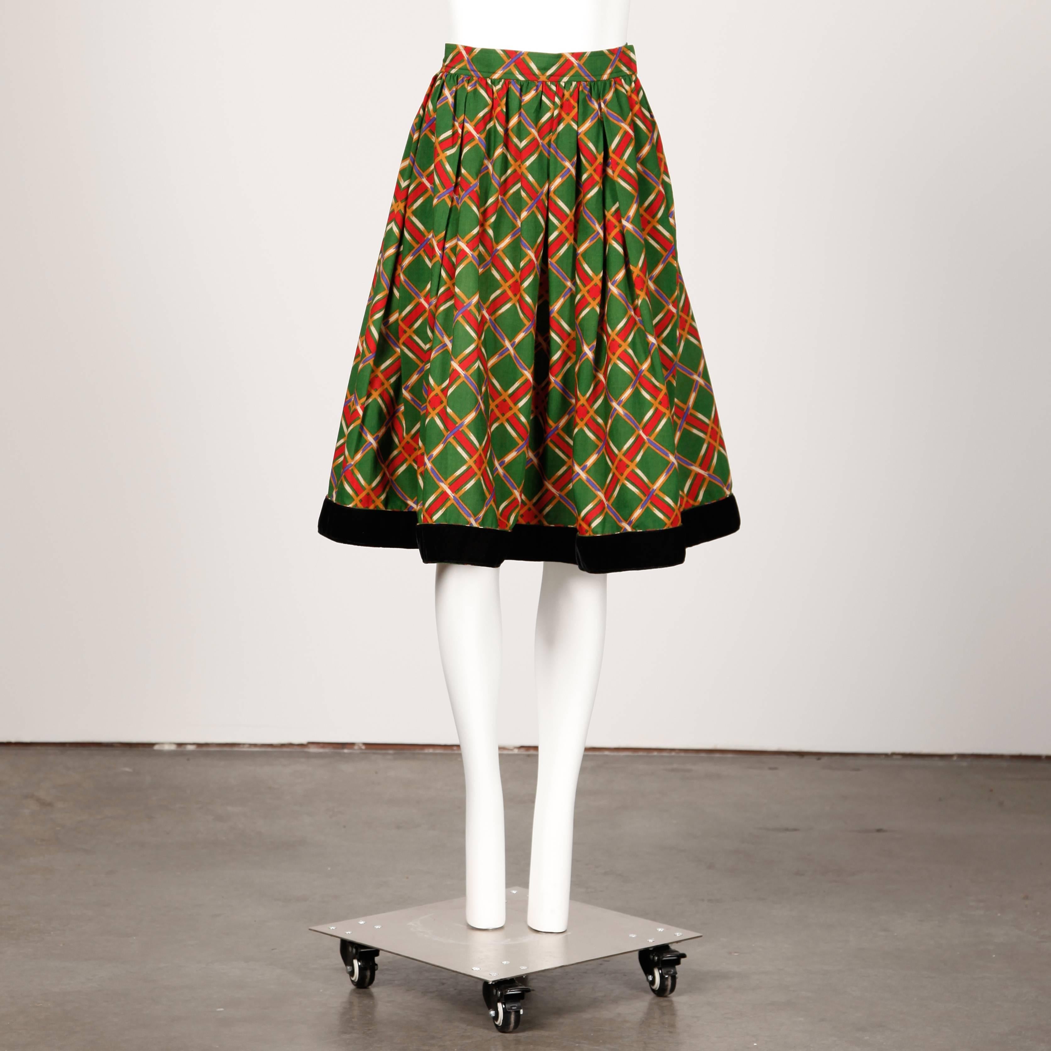 Early Yves Saint Laurent! Vintage 1970s plaid wool midi skirt with a velvet hemline. The marked size is 42 and the skirt fits like a size large.

Details:

Unlined
Front Pockets in Pleats
Side Zip with Snap and Hook Closure
Marked Size: