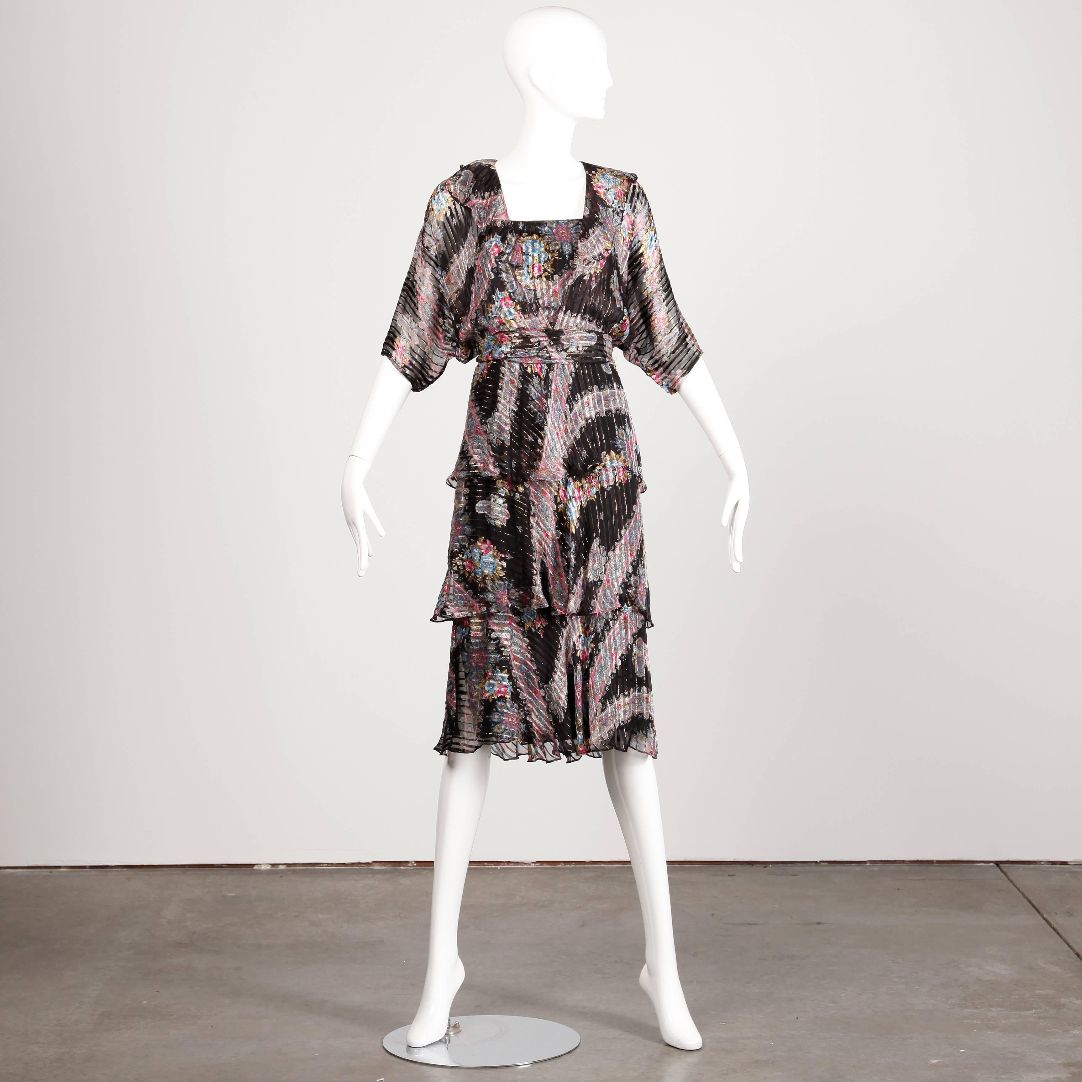 Stunning metallic flecked paper thin silk dress with a paisley print by The Silk Farm by Icinoo. Dolman sleeves and matching sash. The dress is a marked size 4 and fits like a modern size small.

Details: 

Partially Lined
Marked Size: