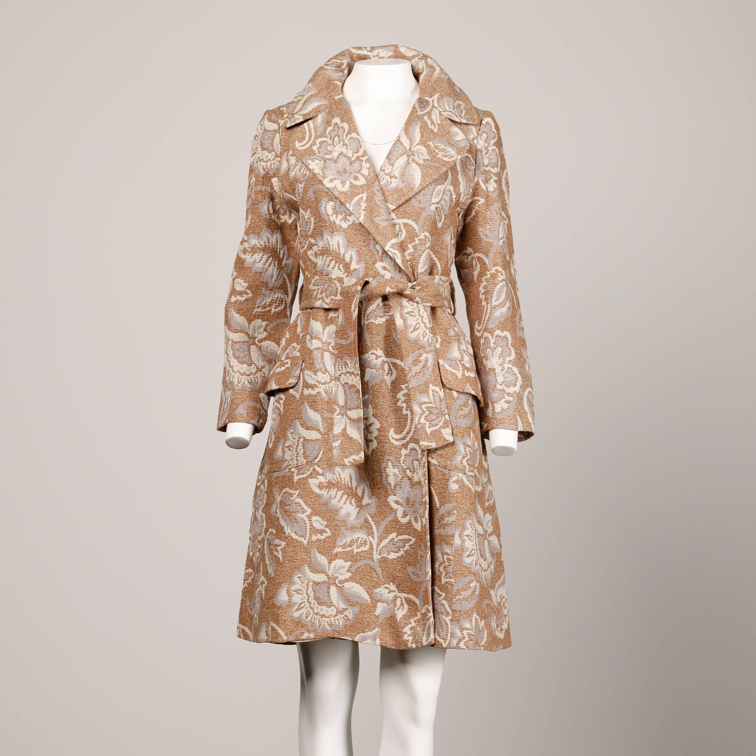 Chic 1970s tapestry coat by Lazarus in neutral tones of woven chenille. Matching wast sash and notched lapels.

Details: 

Fully Lined
Front Box Pockets
Snap Front Closure with Sash
Marked Size: Unmarked
Estimated Size: Small-Medium
Color: