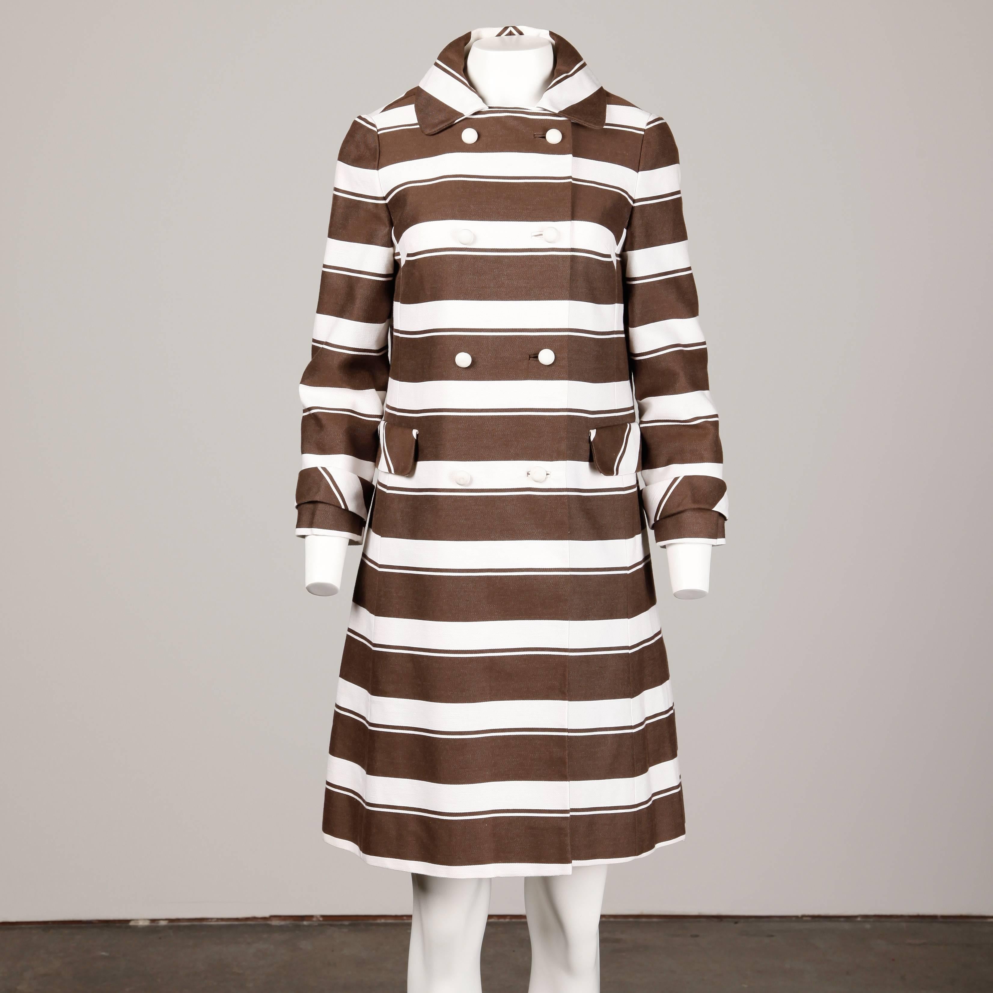 Vintage brown and white striped mod coat with bobble buttons by Sandra Sage. This fits like a modern size small.

Details: 

Fully Lined
Side Seam Pockets
Button Front Closure
Marked Size: Unmarked
Estimated Size: Small
Color: Brown/ White