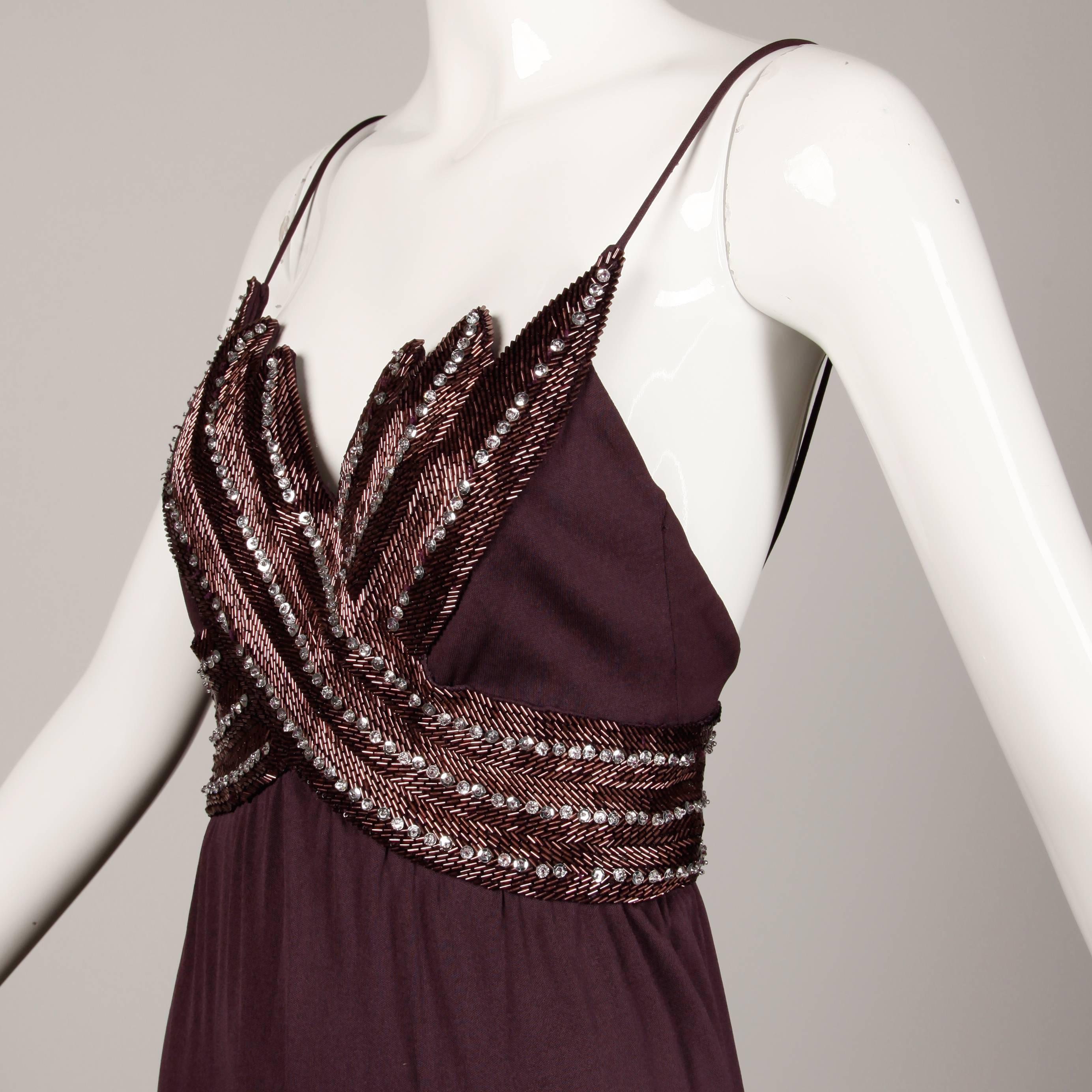Slinky vintage 1970s plum silk jersey disco dress with metallic sequins and beading by Victoria Royal for I. Magnin. Fully lined with rear metal zip, snap and hook closure.  The marked size is 8, but the dress fits like an XS. The bust measures