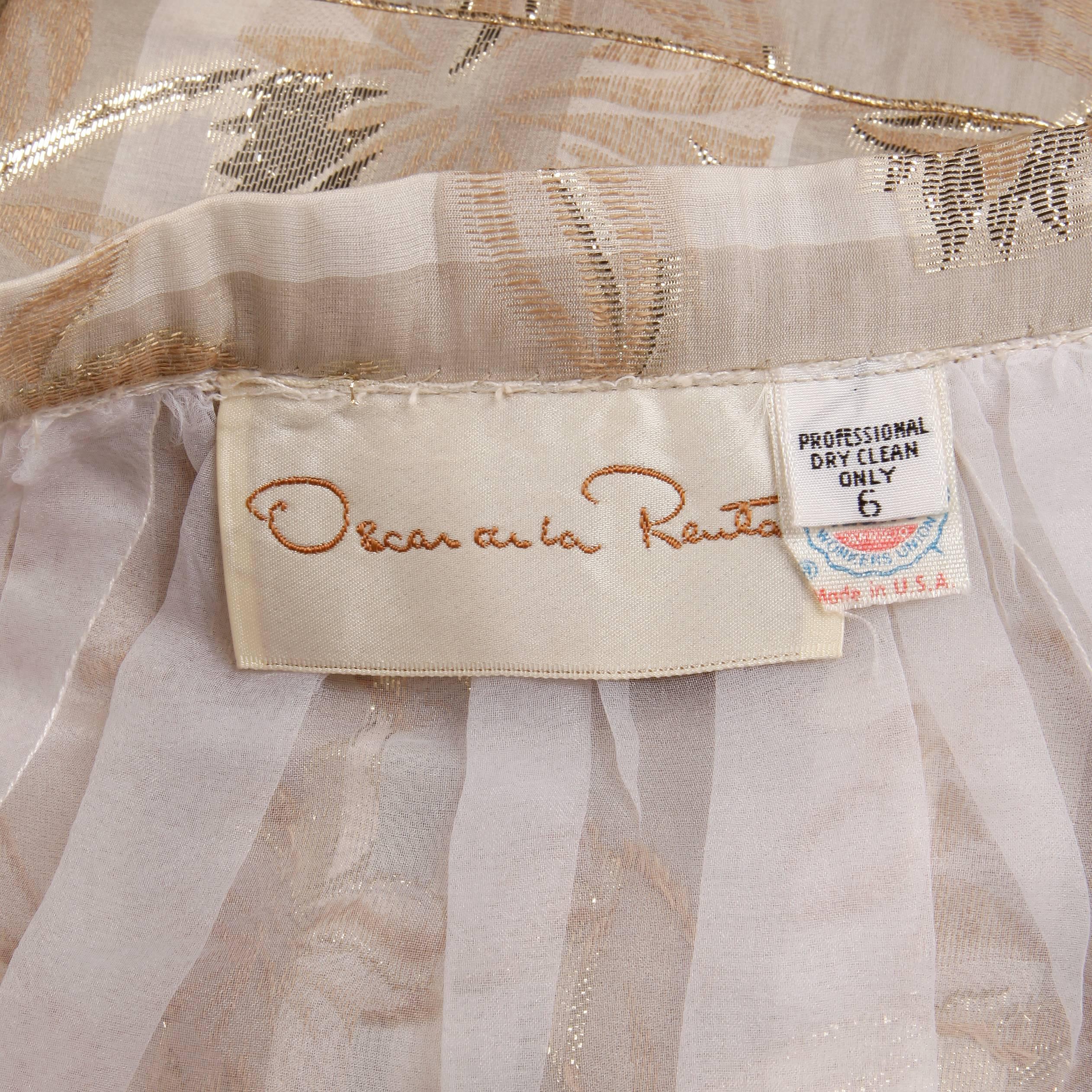 Stunning vintage silk maxi skirt by Oscar de la Renta with an overall white, nude, and metallic gold design. Fully lined with side hook, snap and button closure. The marked size is 6, but the skirt fits like a modern size XS-S. The waist measures
