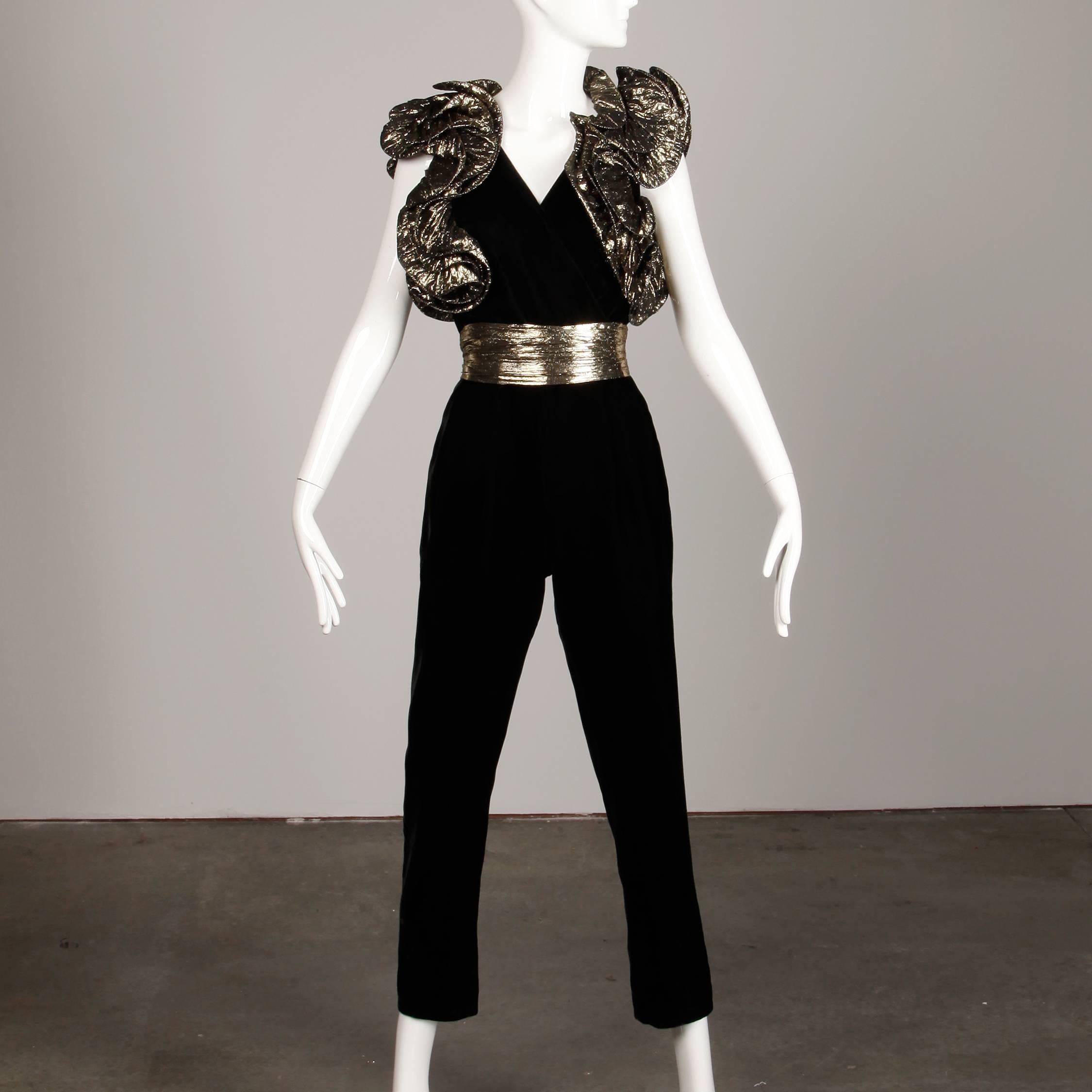 Amazing 1980s vintage jumpsuit with metallic gold lamé ruffled shoulders and belt. Unlined with rear zip closure. 100% rayon. The bust measures 42", waist 26", hips 38", front rise 13.5", back rise 15", inseam 27" and