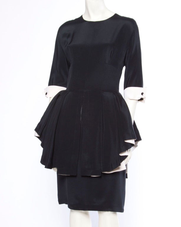Extraordinary Bernard Perris black and off white 100% silk dress with a ruffled peplum and 3/4 length sleeves. Stunning couture construction with hand stitching on the silk interior. Rear zip closure and fully lined in silk. Fits like a modern size