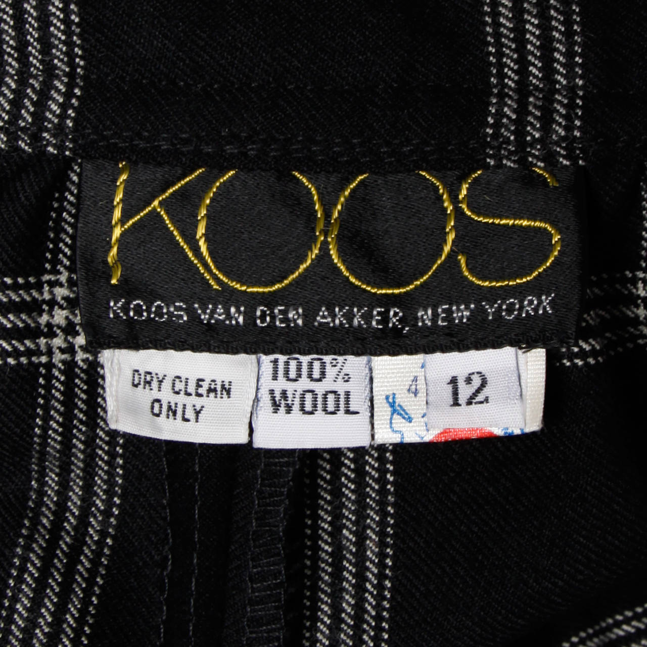 Vintage black and white wool skirt by Koos Van Der Akker. Beautiful quality wool. Unlined with rear zip and hook closure. Fits like a modern size medium. The waist measures 29