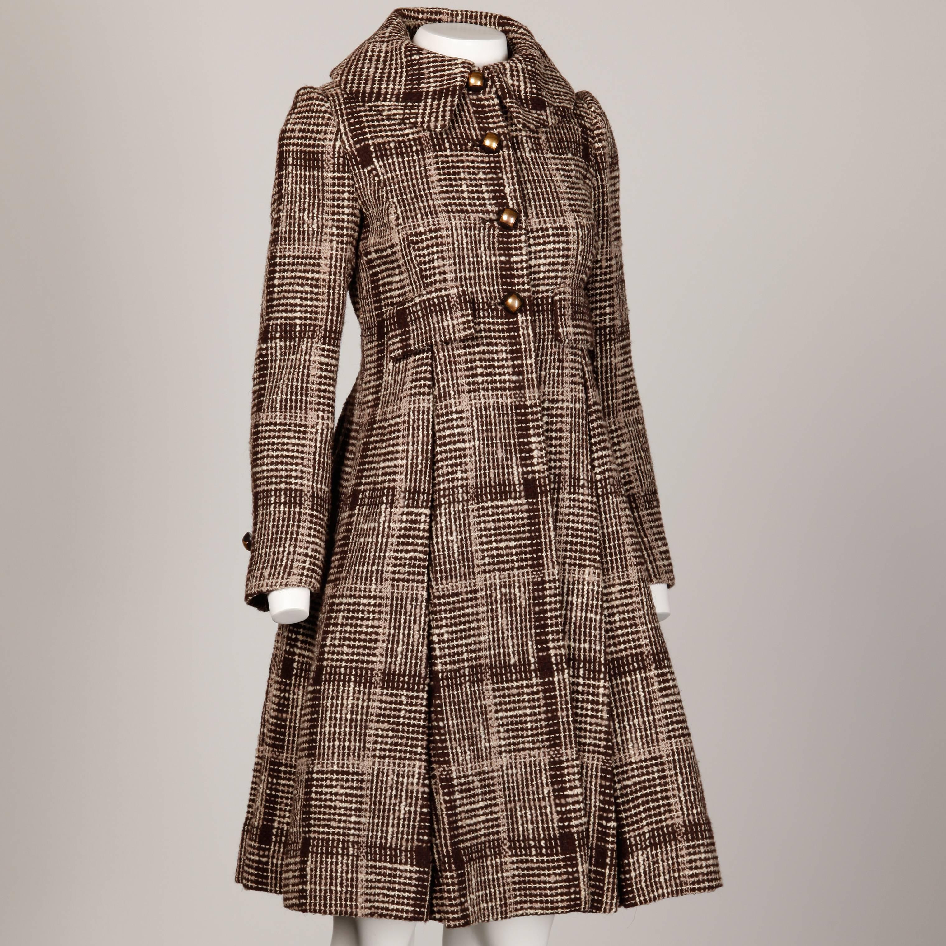 Absolutely stunning vintage Cardinali coat in woven brown tweed. Couture construction with hand stitched detailing throughout. Box pleats and completely unique brass buttons. Peter Pan collar and high nipped waist. This coat is unbelievable in