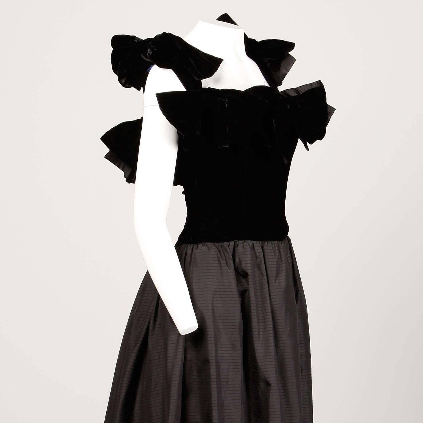 Fantastic 1980s black silk evening gown by Lanvin. Giant velvet avant garde bows and full silk back train. Built in tulle crinoline and double zip side closure. Fully lined with side zip and hook closure. The marked size is 40, but the dress fits