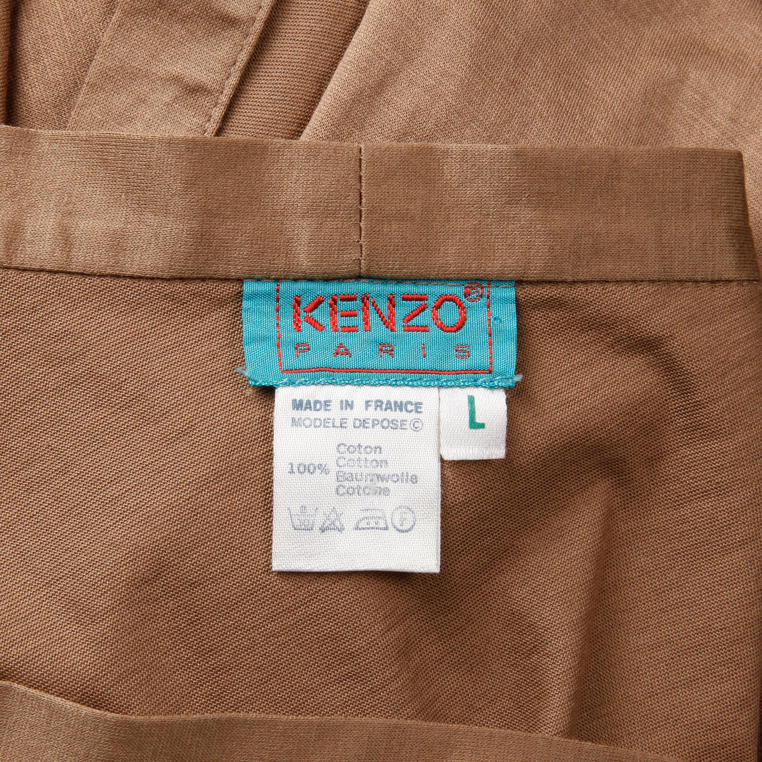 Versatile light weight vintage taupe brown cotton wrap skirt by Kenzo Paris. Unlined with wrap tie closure. The marked size is Large. 100% cotton. The marked size is large, but the skirt will also likely fit sizes small-medium on account of the