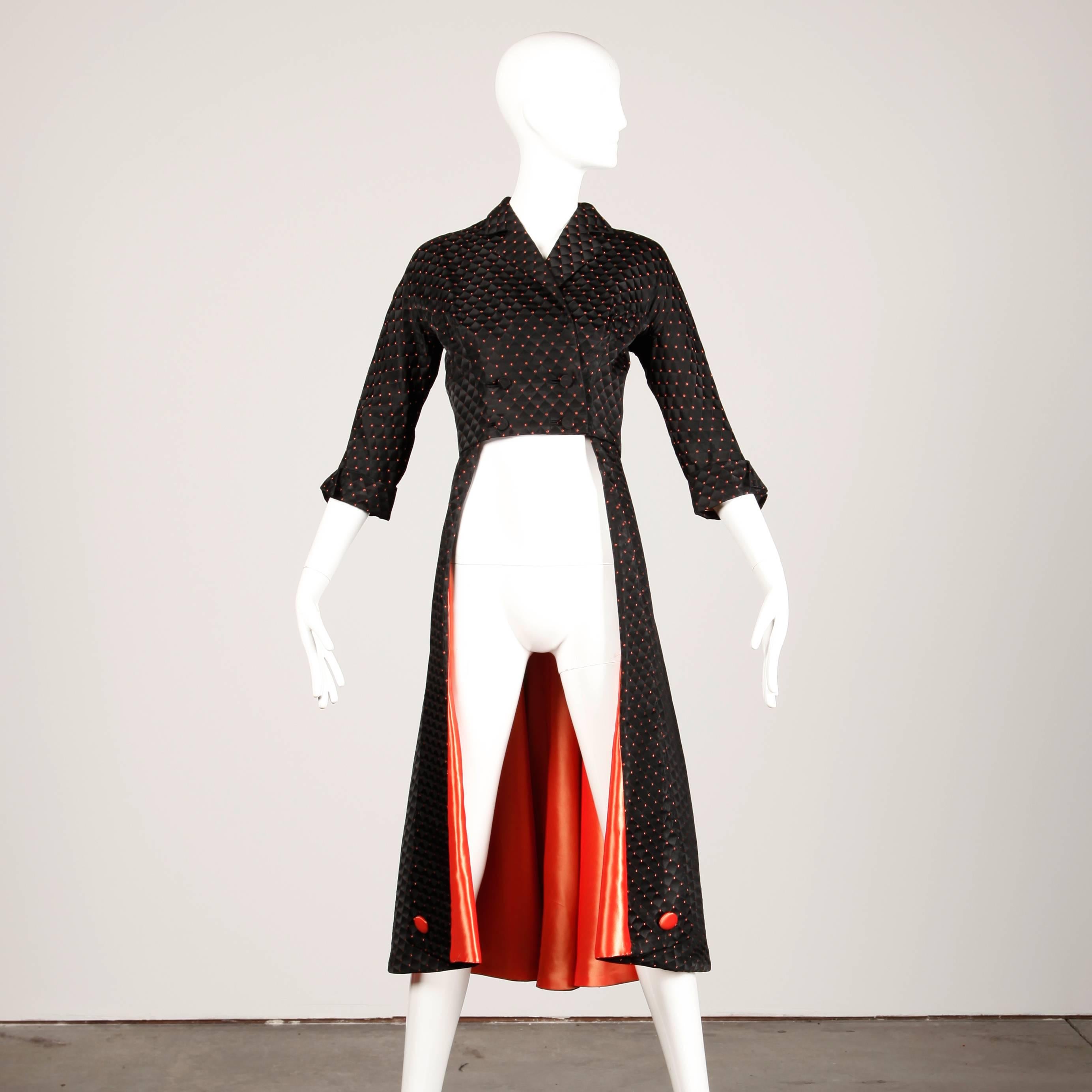 Incredible vintage 1950s black and coral satin coat that is meant to be worn over a dress or skirt. Full sweep long back and cut out open front. Fully lined with front button and snap closure. Fits like a modern size small. The bust measures 36