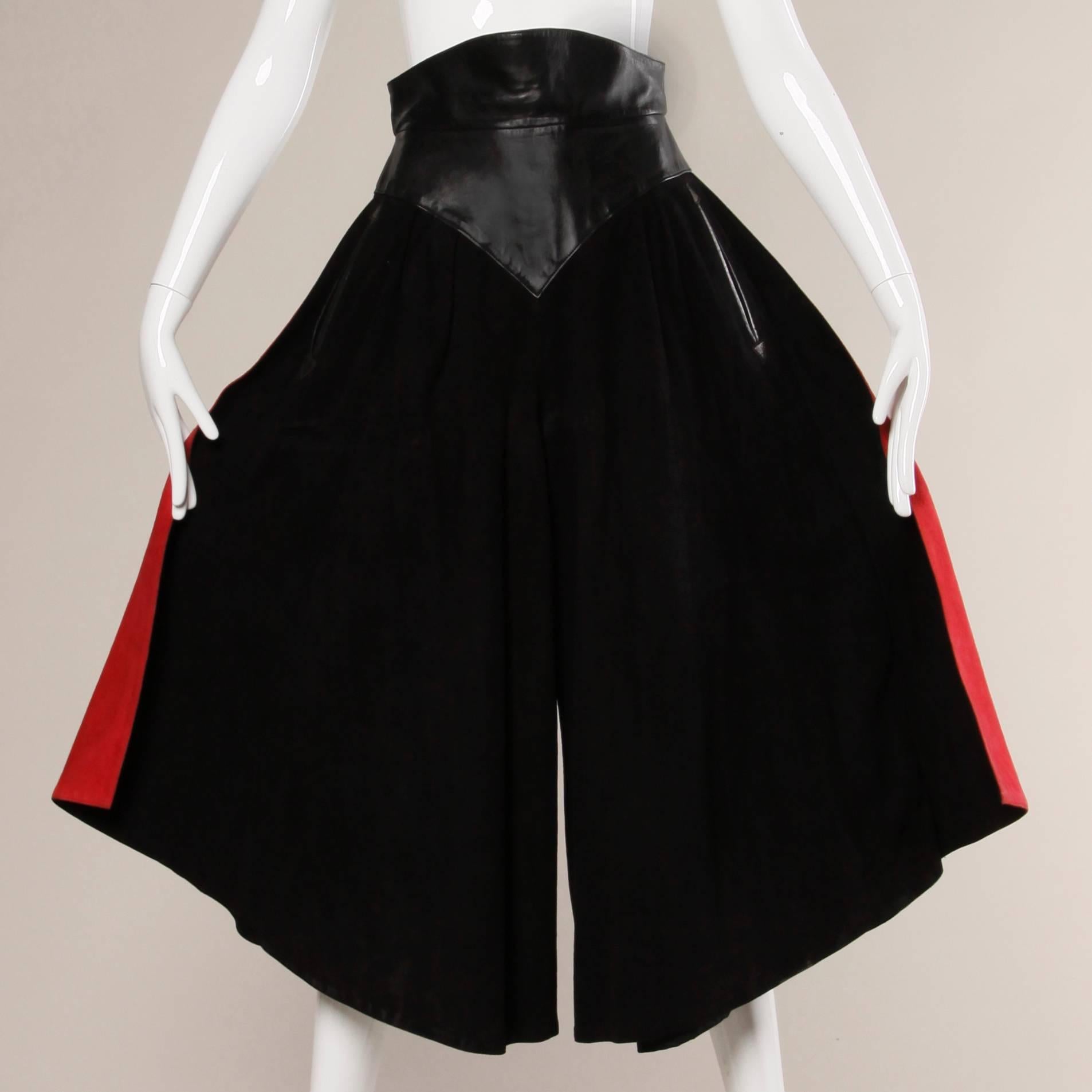 Incredible vintage Claude Montana Pour Ideal Cuir black suede culottes with buttery black leather waistband and red suede panels along the side of each leg. Unique design and amazing craftsmanship!

Details:

Lined
Back Zip Closure
Marked