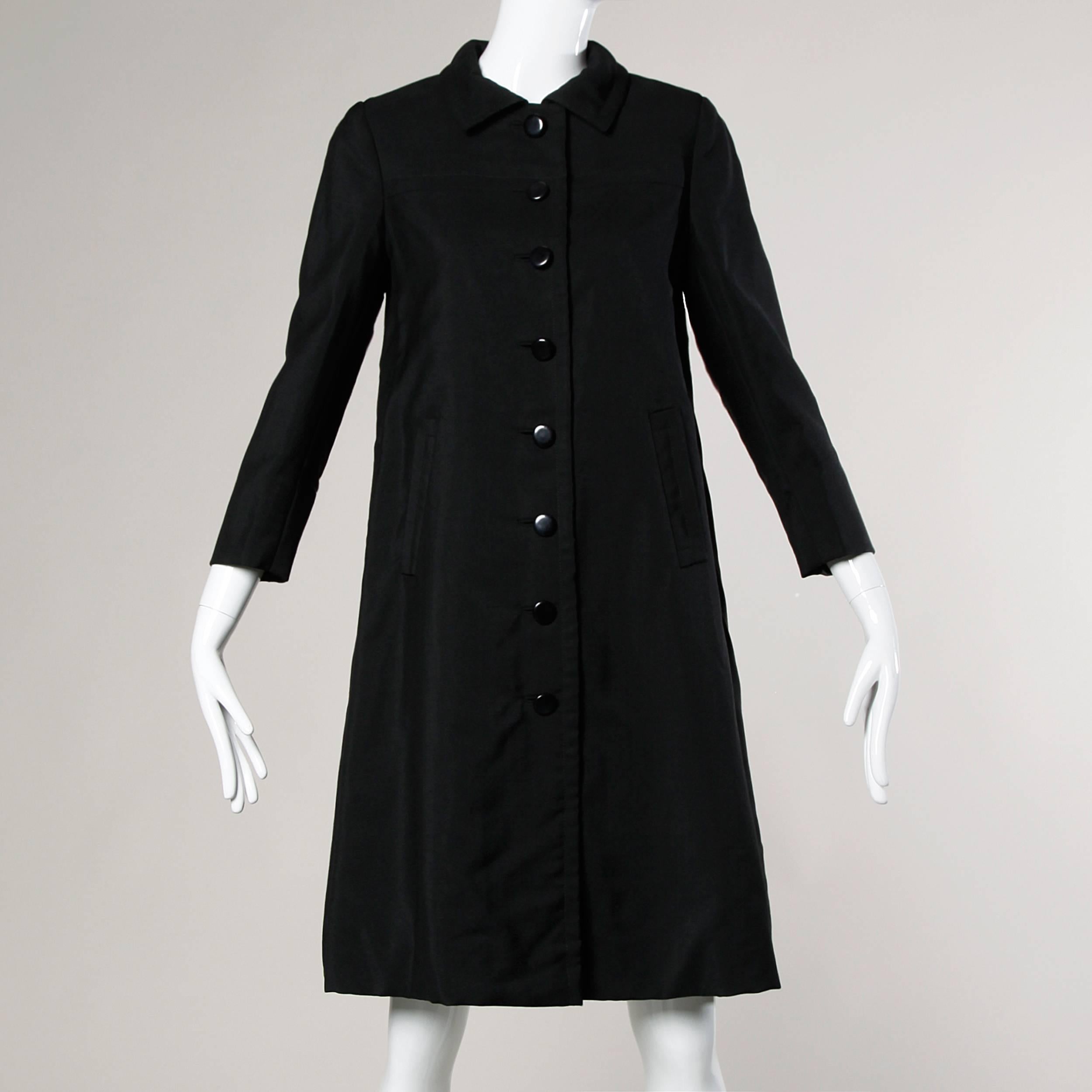 Stunning couture construction! Vintage 1960s Ben Zuckerman for I. Magnin wool and silk swing coat with pristine tailoring and bound button holes. Simple and chic.

Details:

Fully Lined
Shoulder Pads Are Sewn Into Lining
Front Button and Snap