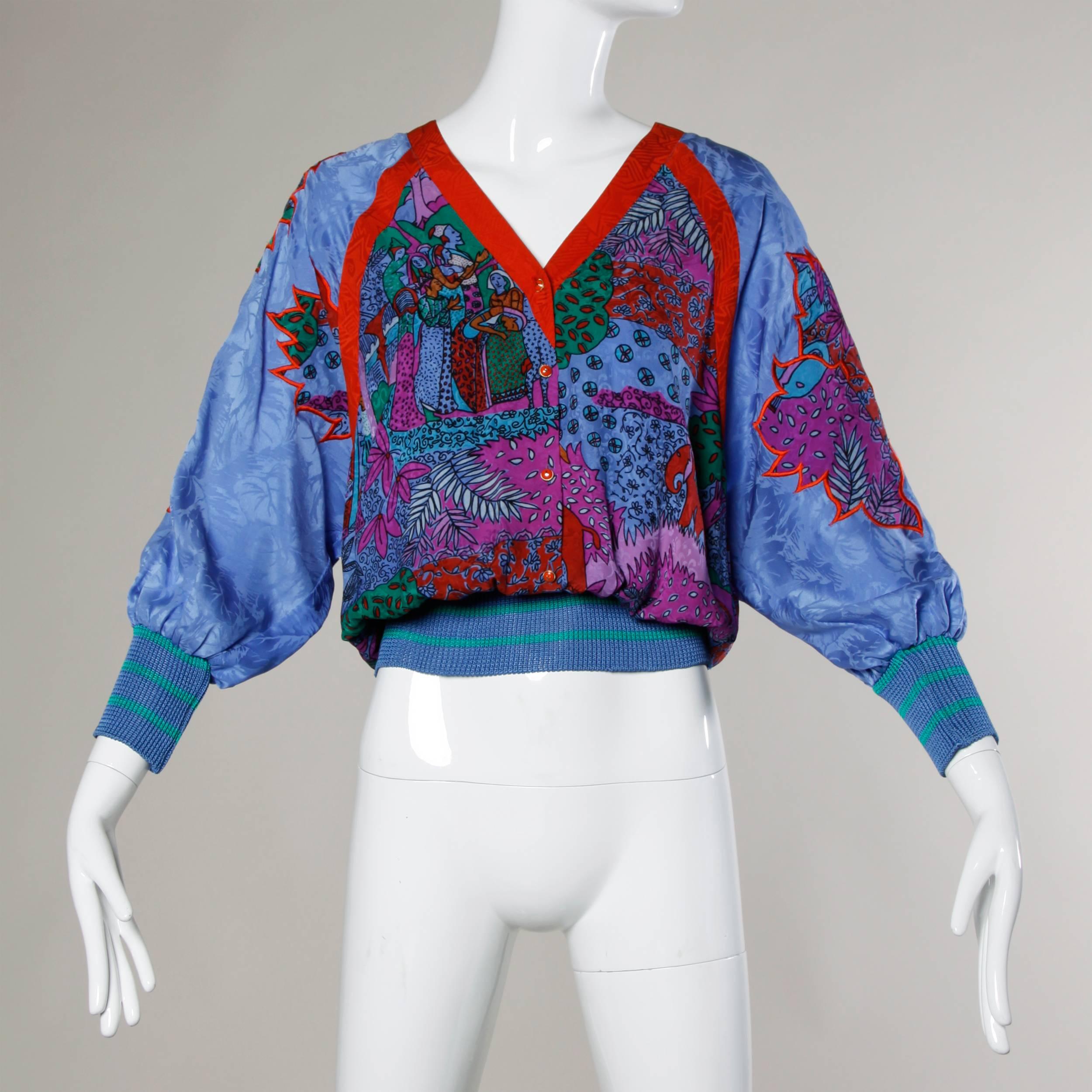 Silk patchwork pullover blouse by Diane Fres with a vibrant bohemian print and blouson sleeves.

Details:

Unlined
Front Button Closure
Marked Size: Not Marked
Estimated Size: S-M
Color: Red Orange/ Blue Lavender/ Multicolor
Fabric: 100%