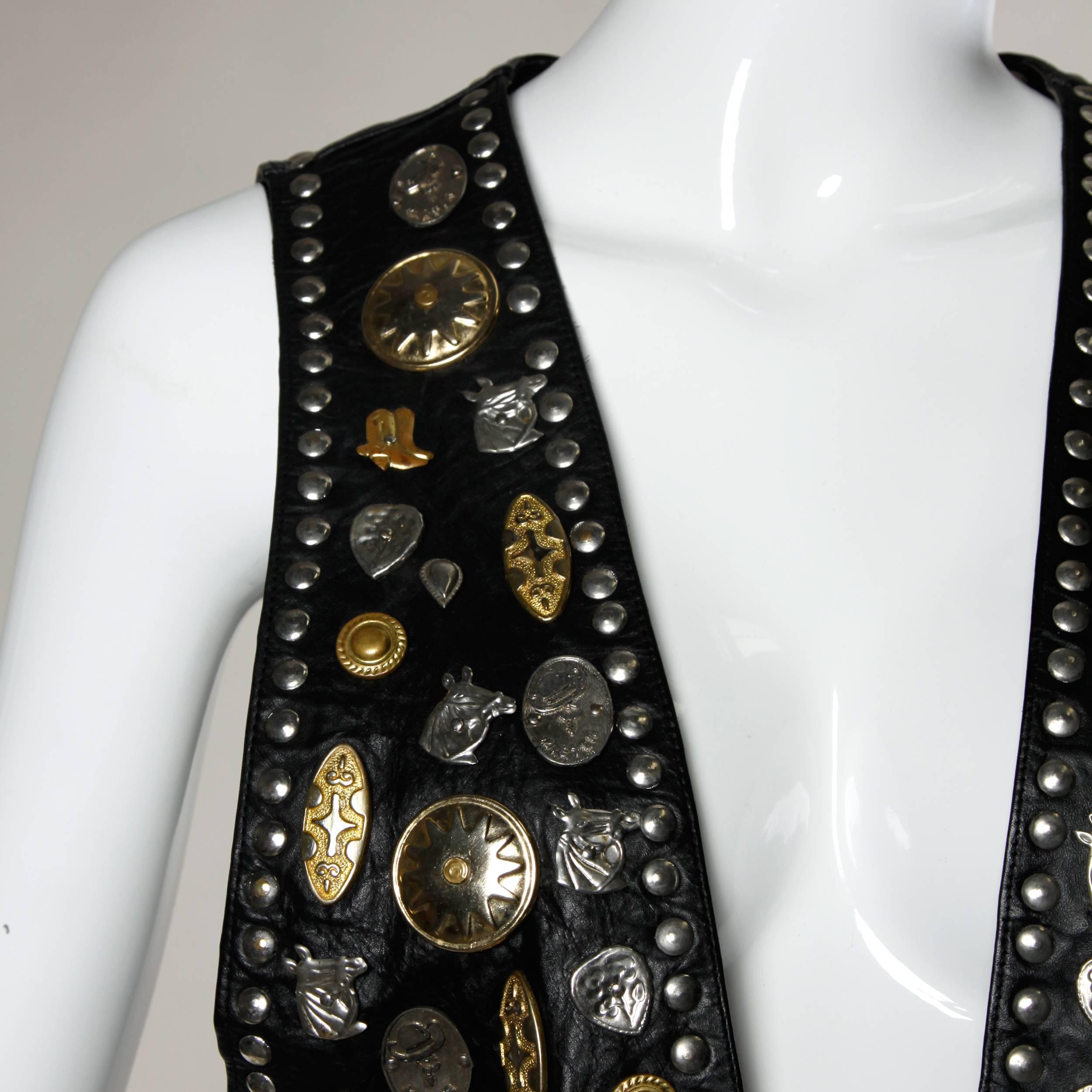 Unique vintage leather vest with oversized novelty studwork featuring horses, cowboy boots and conchos. Heavy and hand made!

Details:

Fully Lined
No Closure
Marked Size: Not Marked
Estimated Size: Free
Color: Black/ Gold and Silver