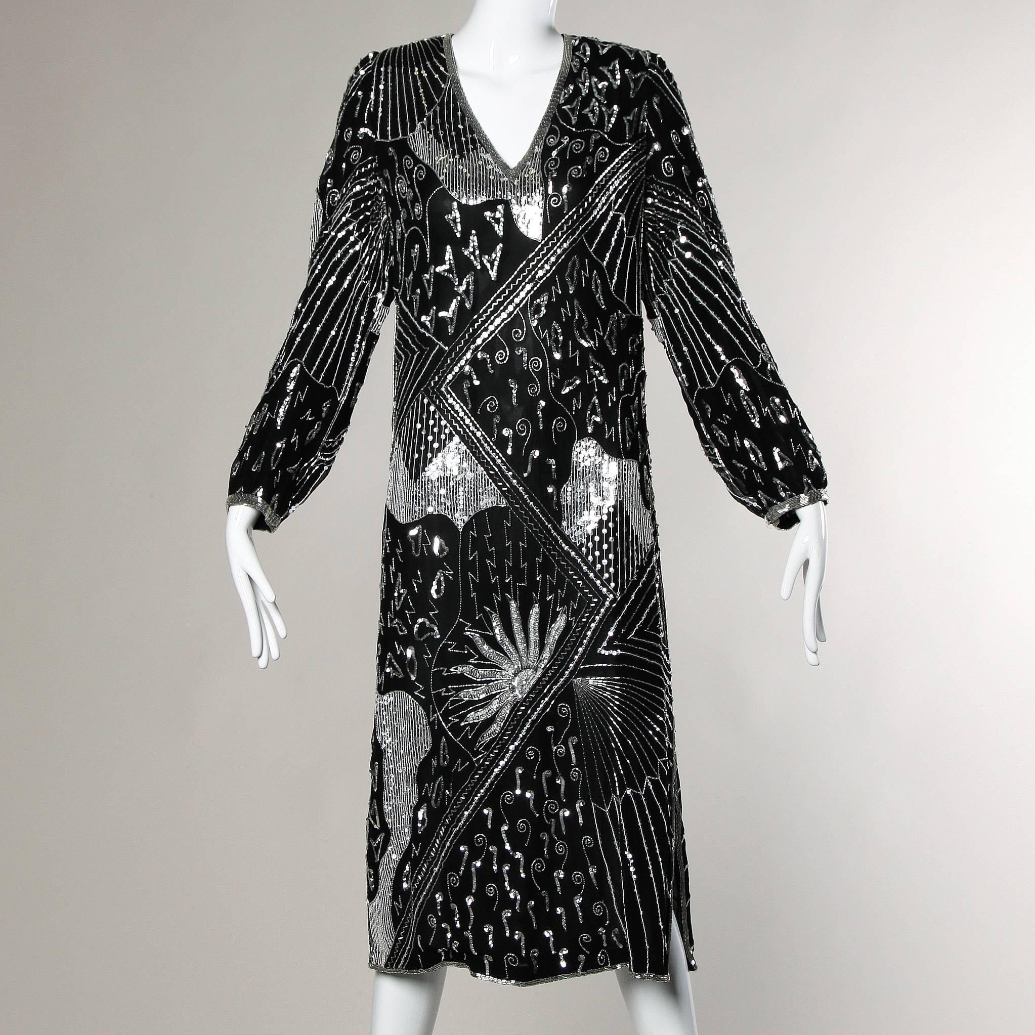 Flapper-inspired silk beaded and sequin dress with a V-neck and side slits by Saks Fifth Avenue.

Details:

Fully Lined
Shoulder Pads Can Easily Be Removed If Desired
Marked Size: M
Estimated Size: S-M
Color: Black/ Silver Metallic 
Fabric:
