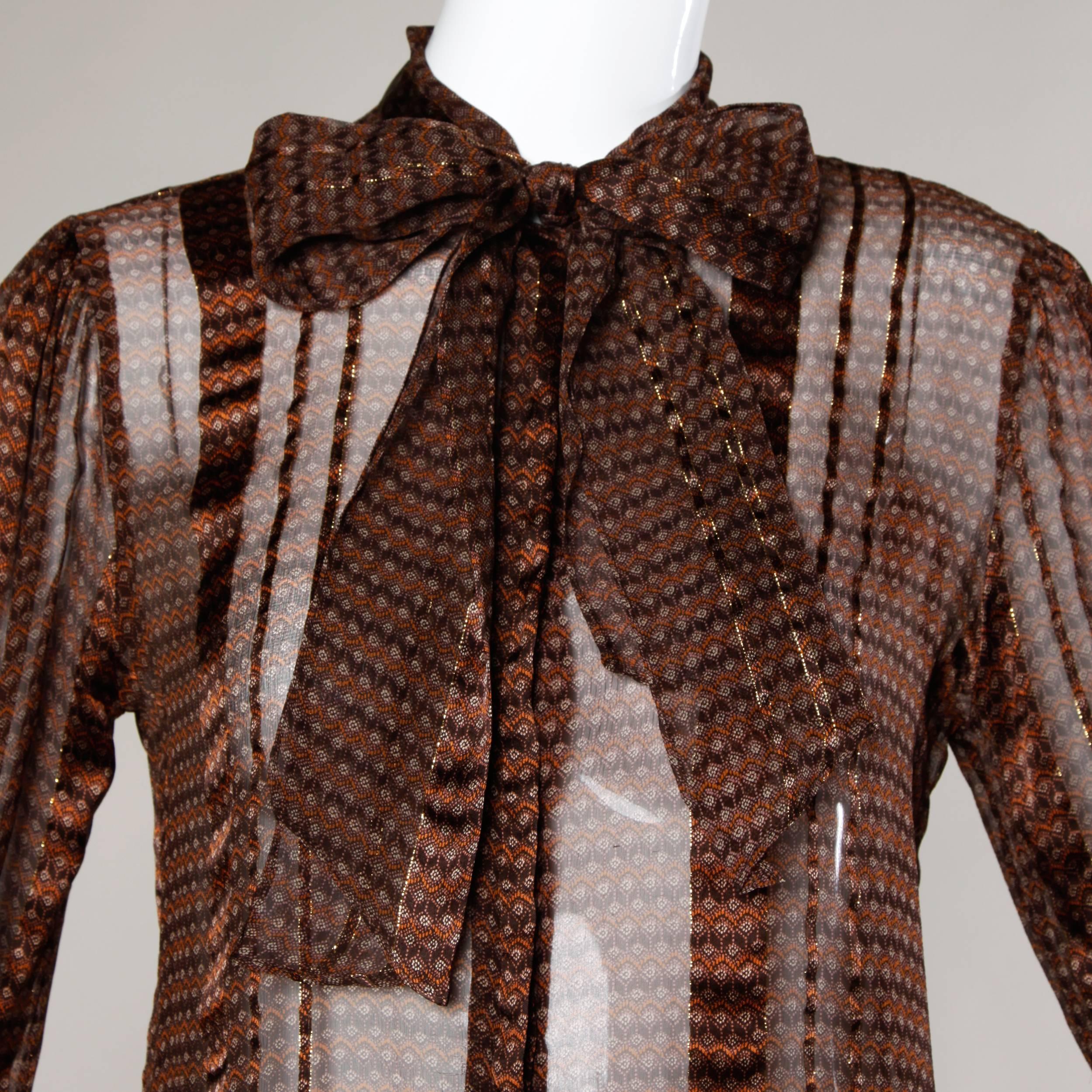 Delicate paper thin silk button up blouse with an ascot bow tie. Completely sheer with a bohemian print.

Details:

Unlined
Front Button Closure
Marked Size: US 10
Estimated Size: M
Color: Brown Multicolor
Fabric: 100% Silk
Label: Lillie