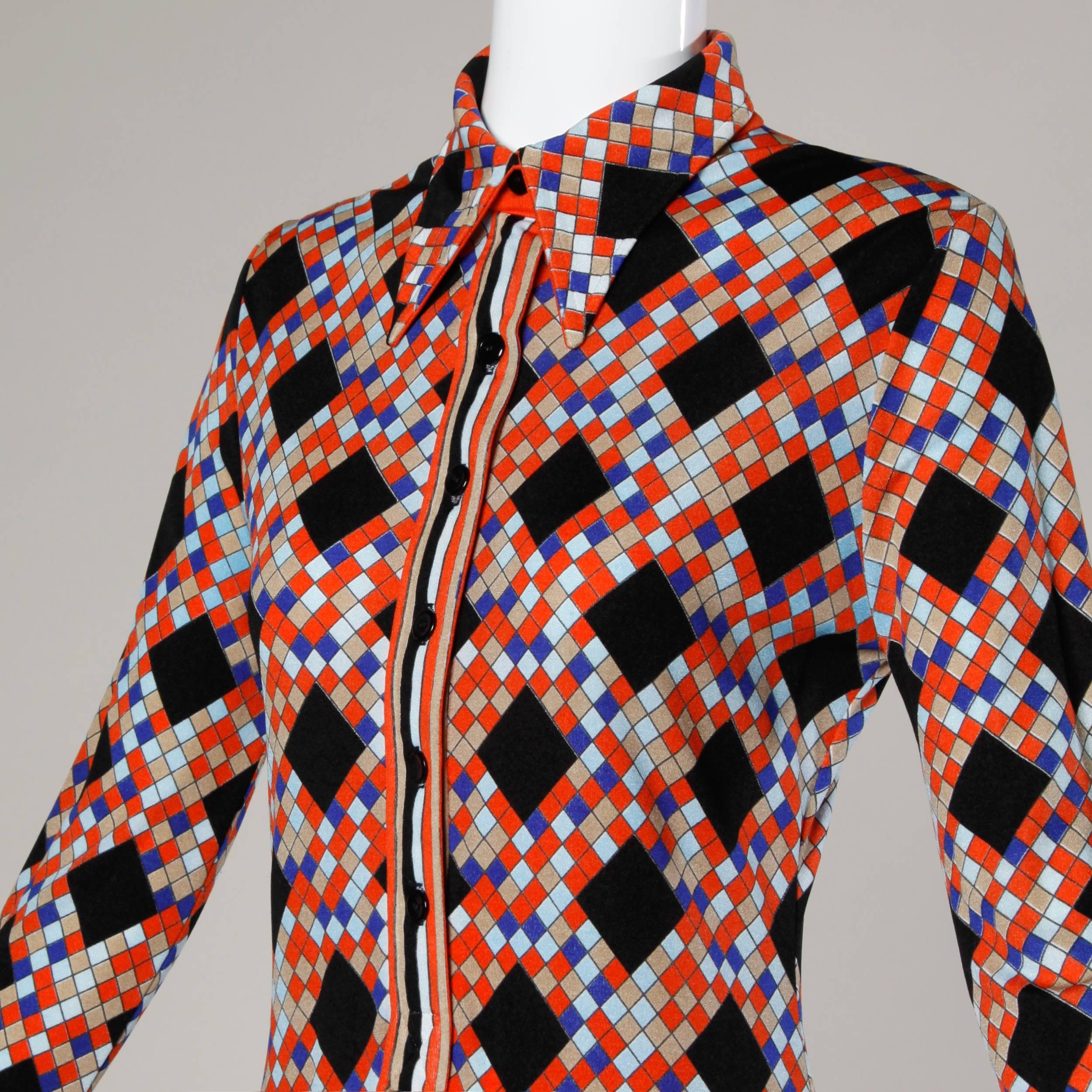 Graphic op art printed shirt dress by Mr. Dino in vibrant colors. Button up front and long sleeves. Unlined light weight jersey knit. Fits like a size small. Bust: 34