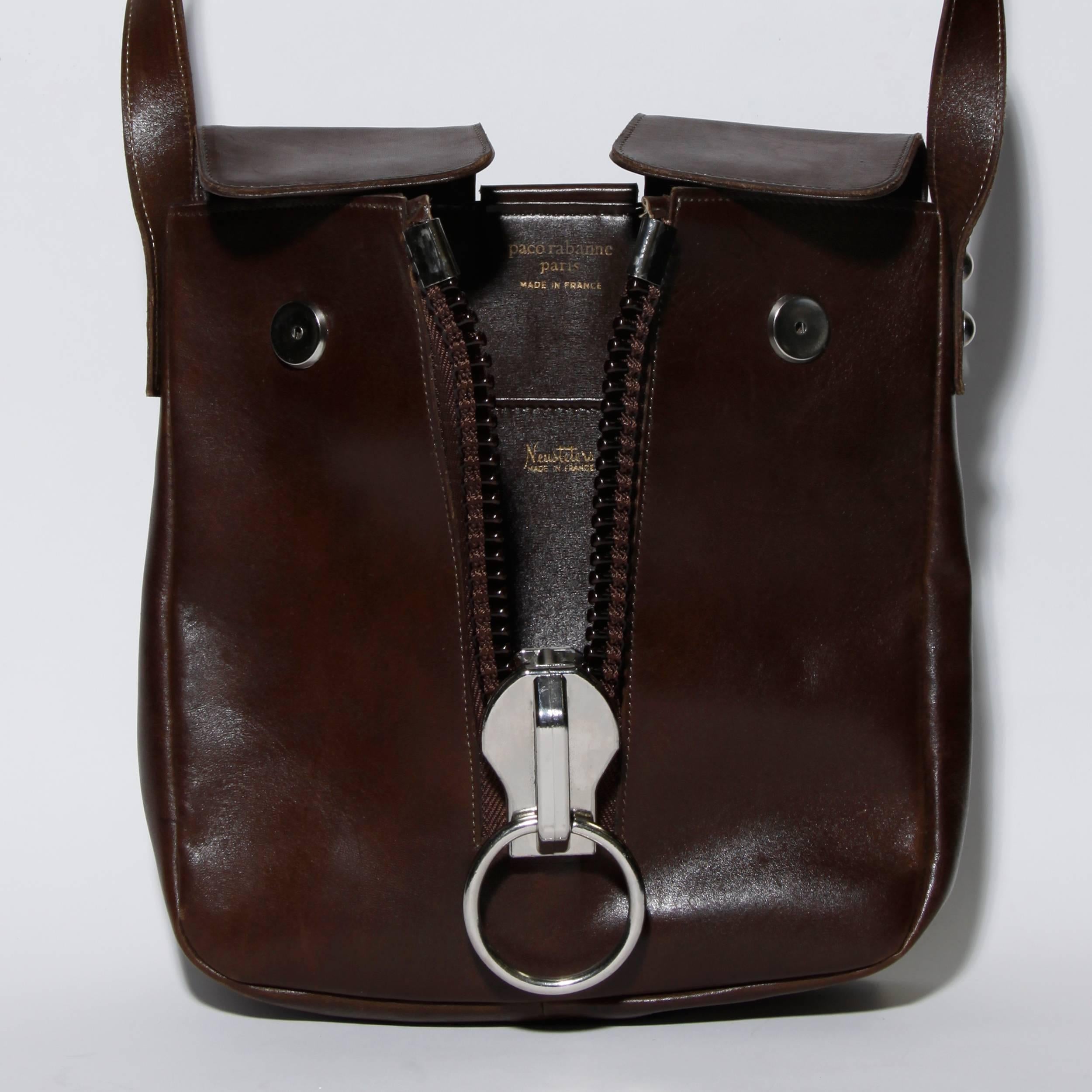 Rare vintage 1960s Paco Rabanne brown leather crossbody bag with a massive oversized metal zipper detail. Incredible modernist design- the zipper works!

Details:

Fully Lined in Leather
Inside Pocket
Front Snap Closure 
Color: