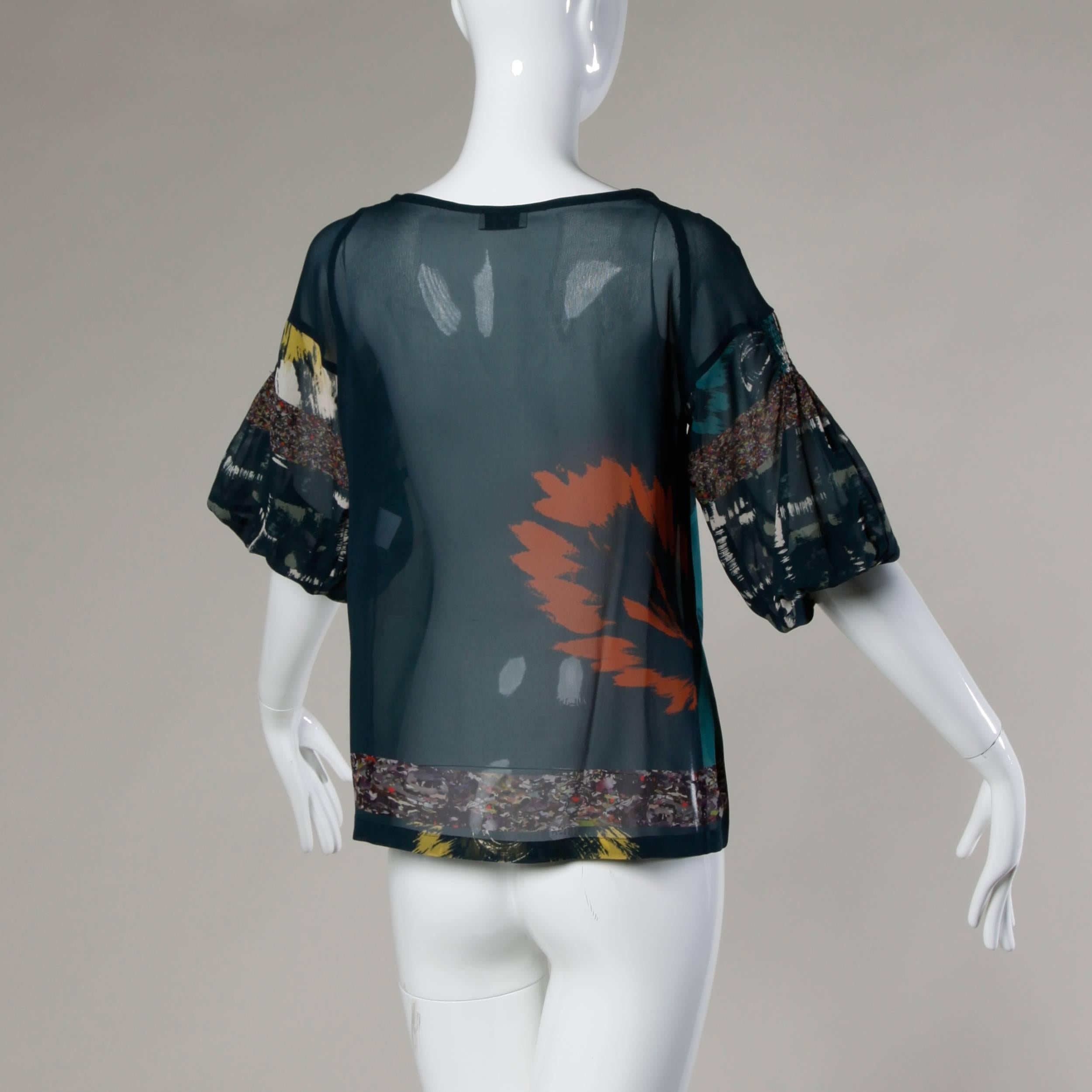 Gorgeous sheer printed top by Dries Van Noten in delicate silk.

Details:

Unlined
Marked Size: 38
Color: Dark Blue Multicolored 
Fabric: Silk
Label: Dries Van Noten

Measurements:

Bust: 36