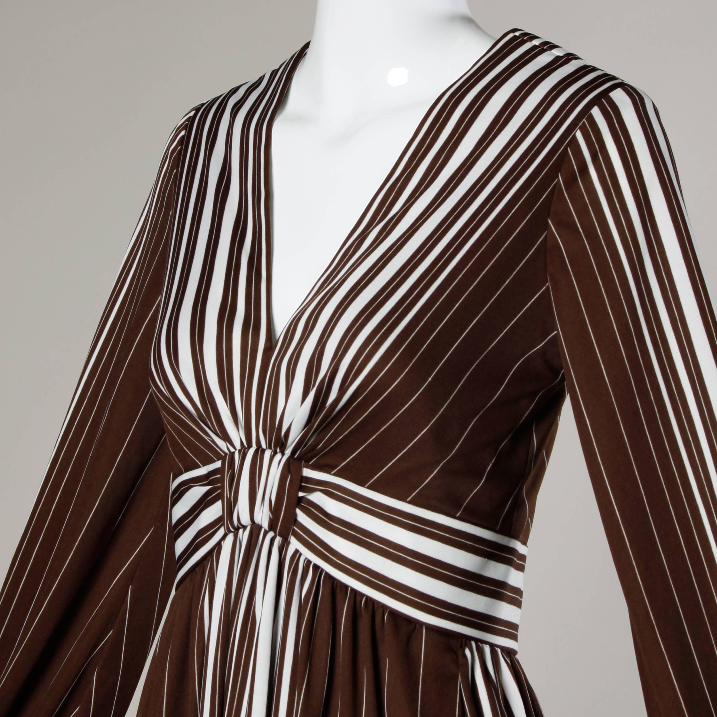 Graphic brown and white striped maxi dress with a plunging neckline by Estevez. Long sleeves and empire waist.

Details:

Back Zip Closure
Estimated Size: Small
Color: Brown/ White
Fabric: Jersey
Label: The Eva Gabor Look by