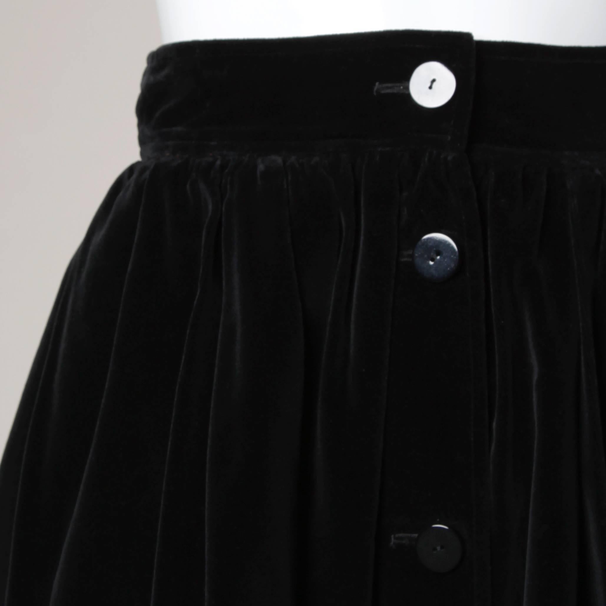 Simple and chic velvet skirt with a button up front by Yves Saint Laurent Rive Gauche.

Details:

Fully Lined
Side Pockets
Front Button and Hook Closure 
Marked Size: F 38
Estimated Size: Small
Color: Black 
Fabric: Velvet
Label: Yves