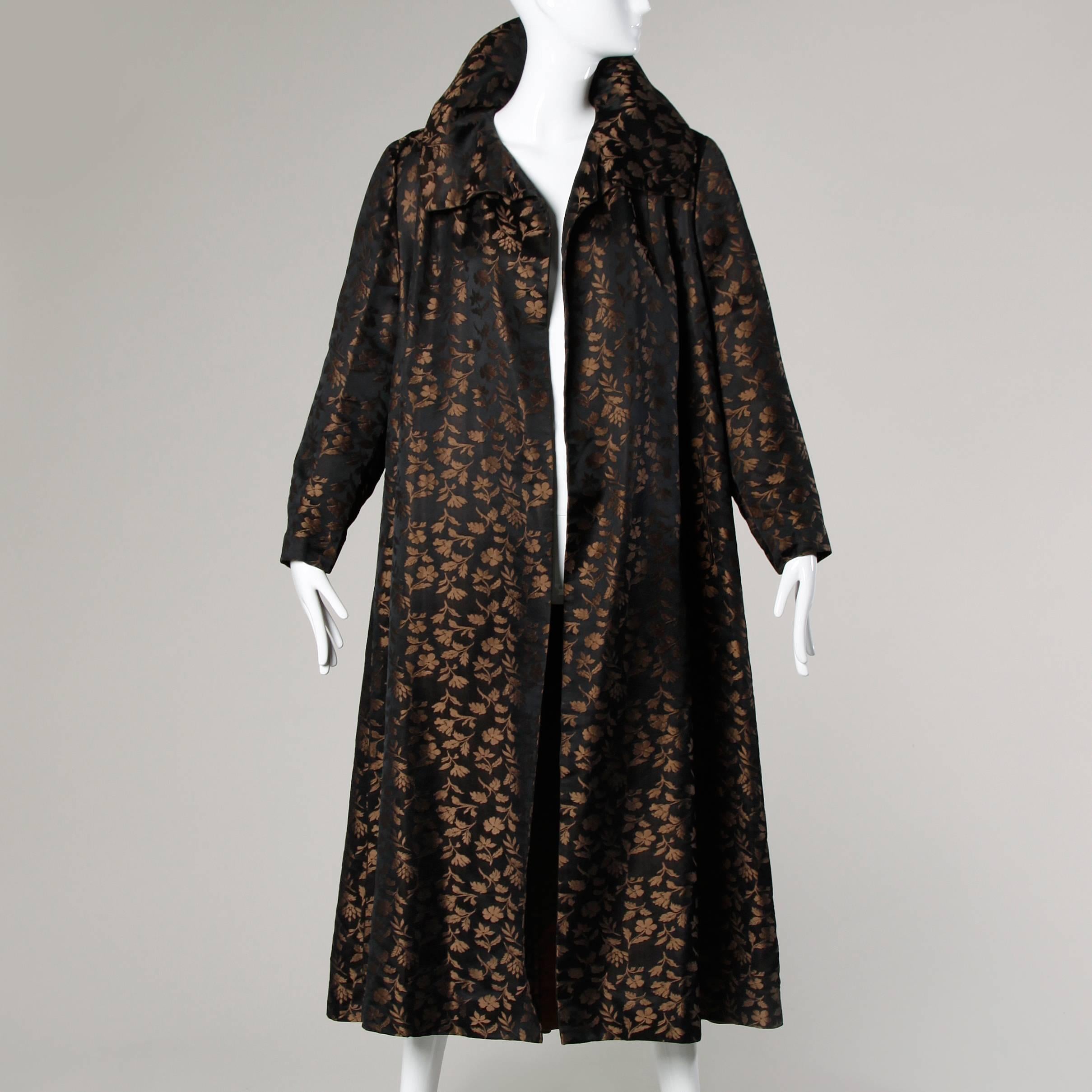 Stunning vintage couture coat by Monte Sano & Pruzan in luxurious silk broade. Unique 1920's-inspired opera style cut with a bubble hem in back and a pop up collar. Beautiful rich brown silk lining. Likely designed by Jacques Tiffeau during his time