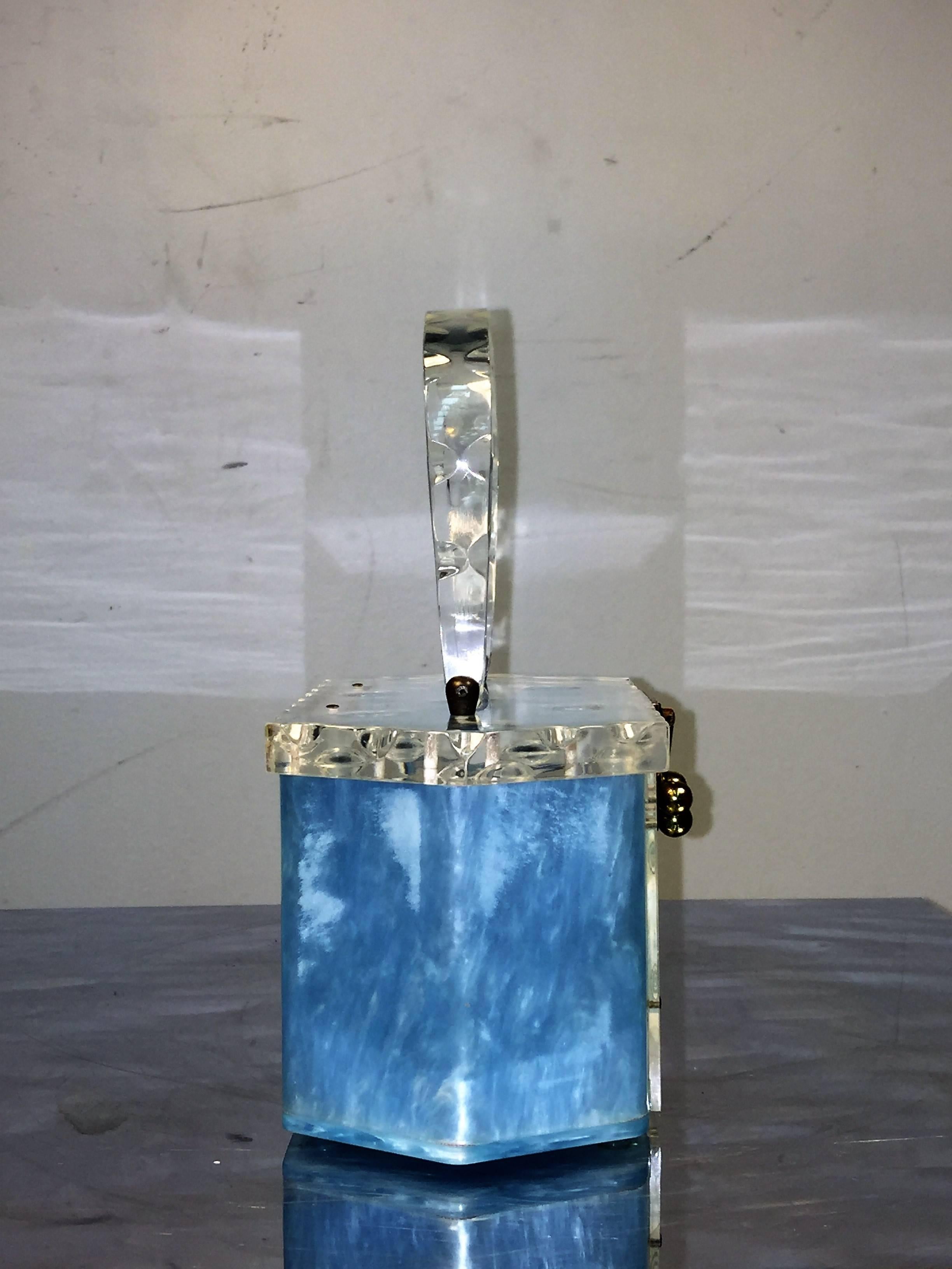 Great Aqua Blue and Clear Carved Lucite Handbag Hand Crafted in Florida in The 1950's.In Perfect Condition no cracks,Chips or damage.The Measurements are9