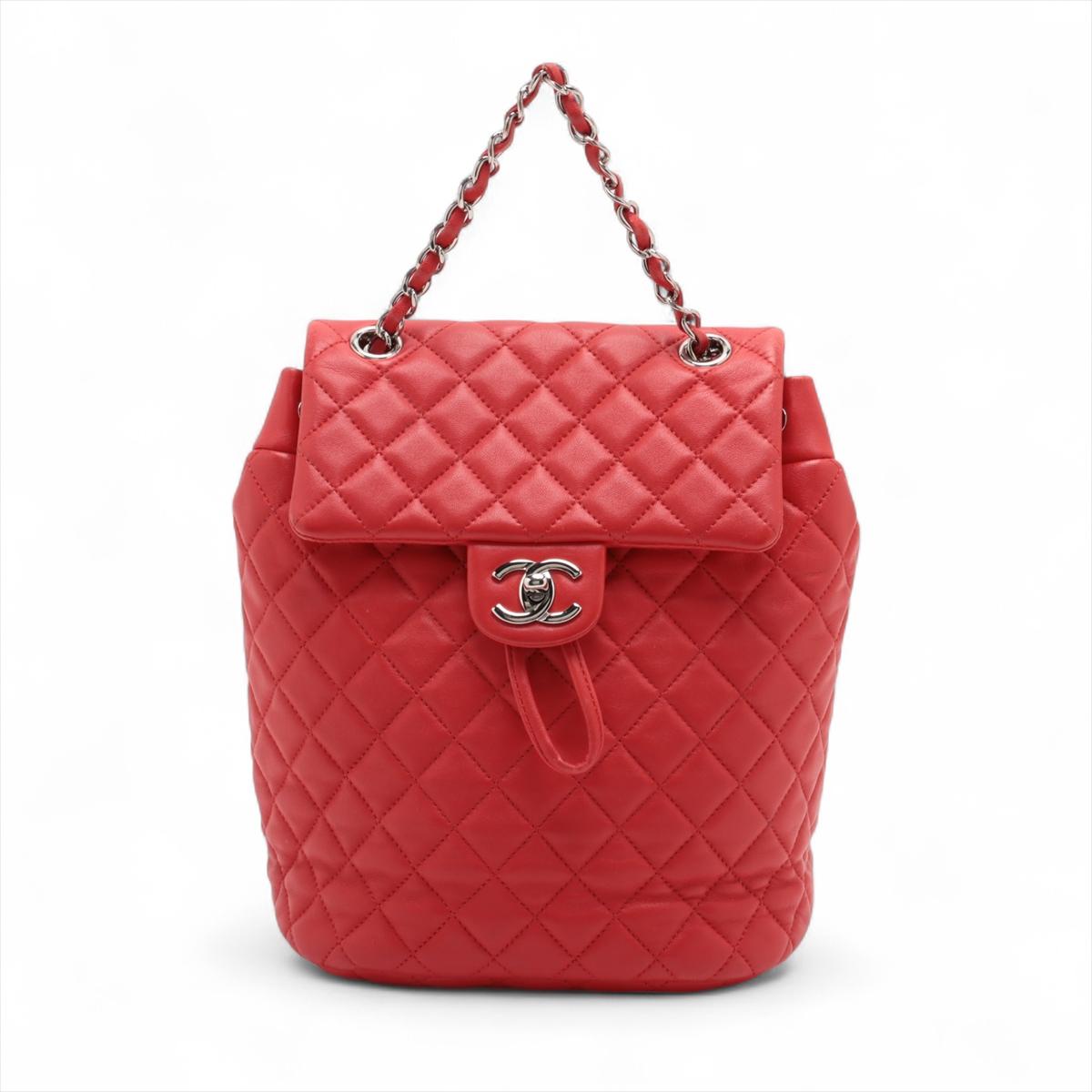 Le sac à dos à cordon de serrage en cuir d'agneau matelassé Chanel CC Logo en rouge est un accessoire luxueux et fonctionnel qui incarne l'élégance intemporelle de Chanel. Confectionné en cuir d'agneau souple, ce sac à dos présente le motif