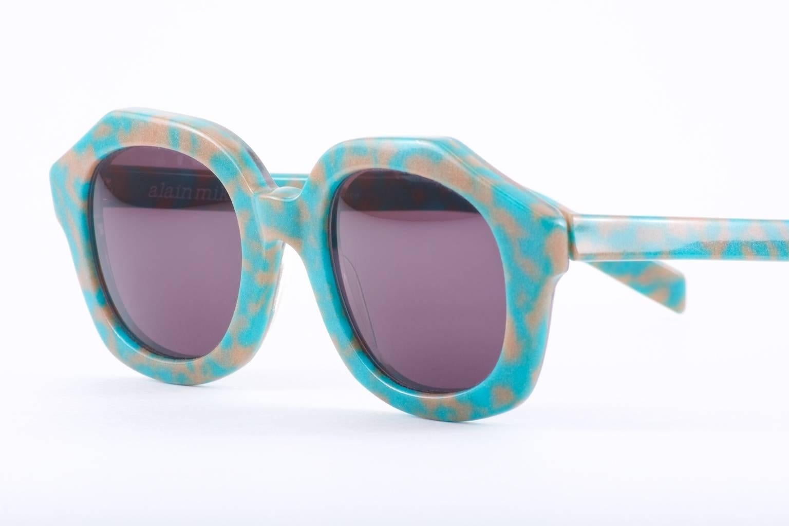 Vintage Alain Mikli sunglasses with these glow-in-the-dark. The sunglasses are blue/teal with grey in daylight but give off a funky green glow in the dark...

